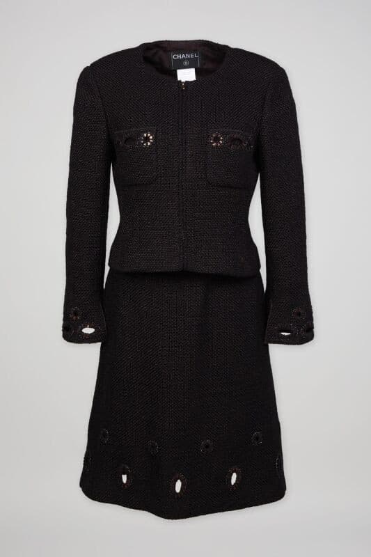 a black chanel suit is on a white background