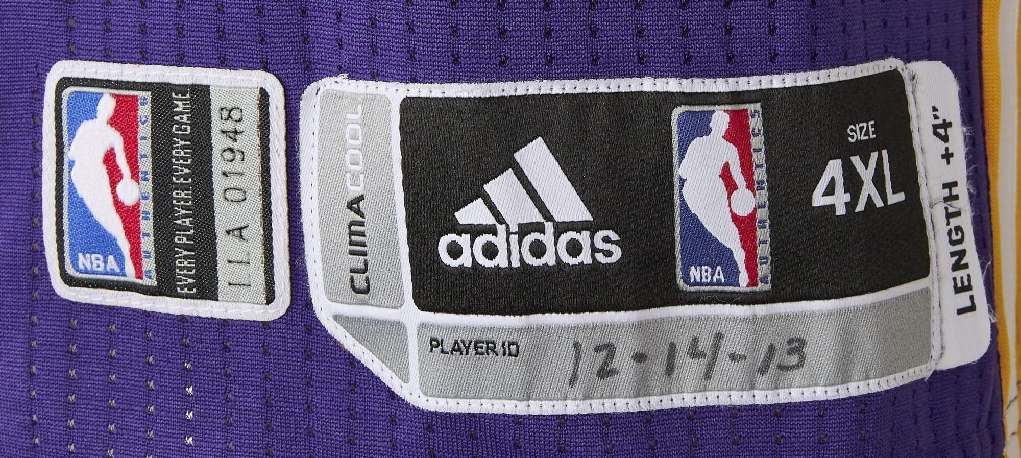 a close up of a purple adidas basketball jersey .