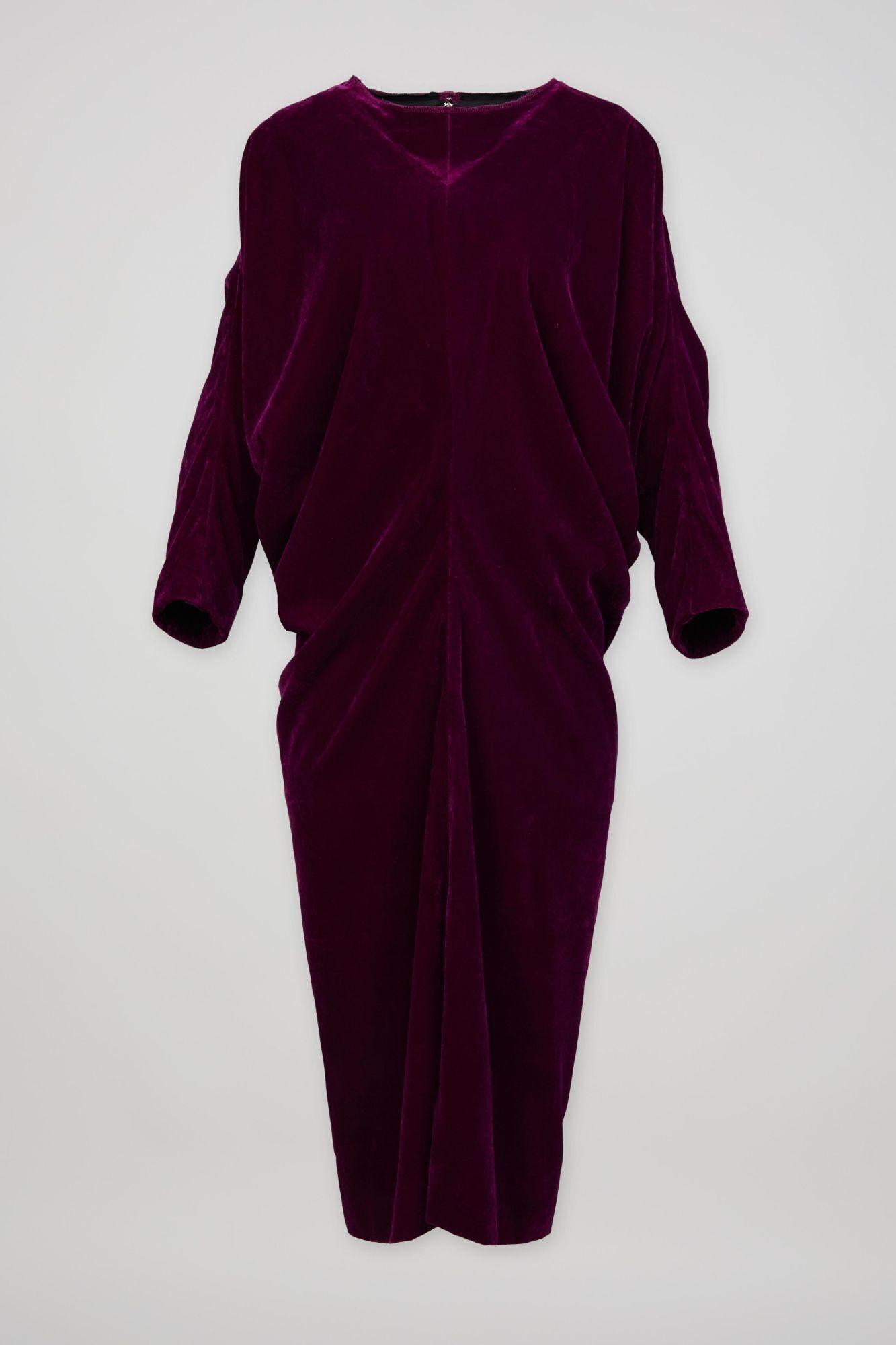 a purple velvet dress with long sleeves on a white background