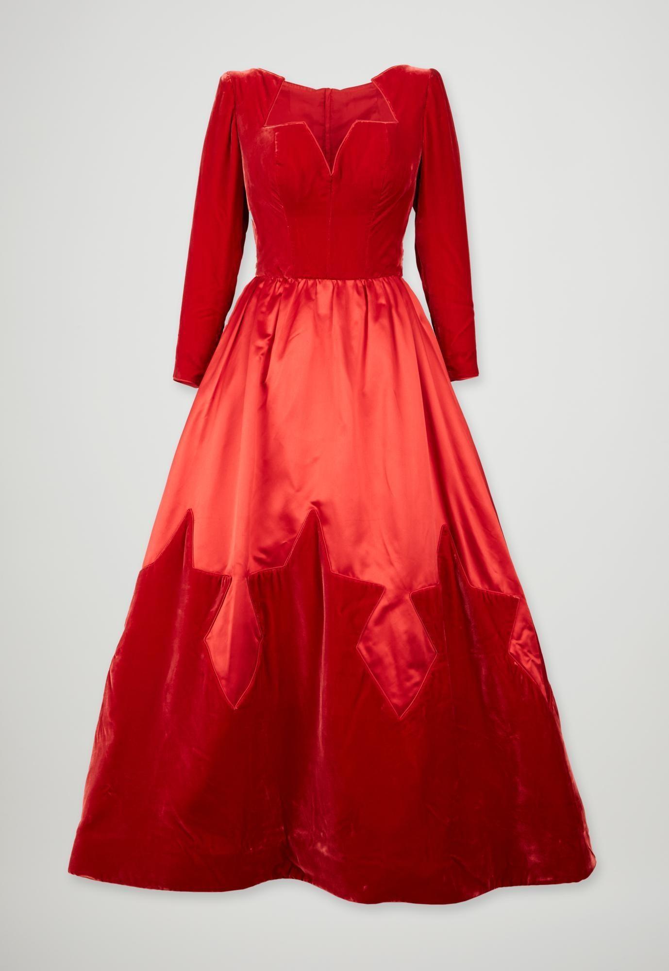 Lot #50. Elizabeth Taylor | Valentino Red Velvet and Satin Ball Gown with Matching Beaded Satin Evening Bag a red velvet dress with long sleeves is on a white background .