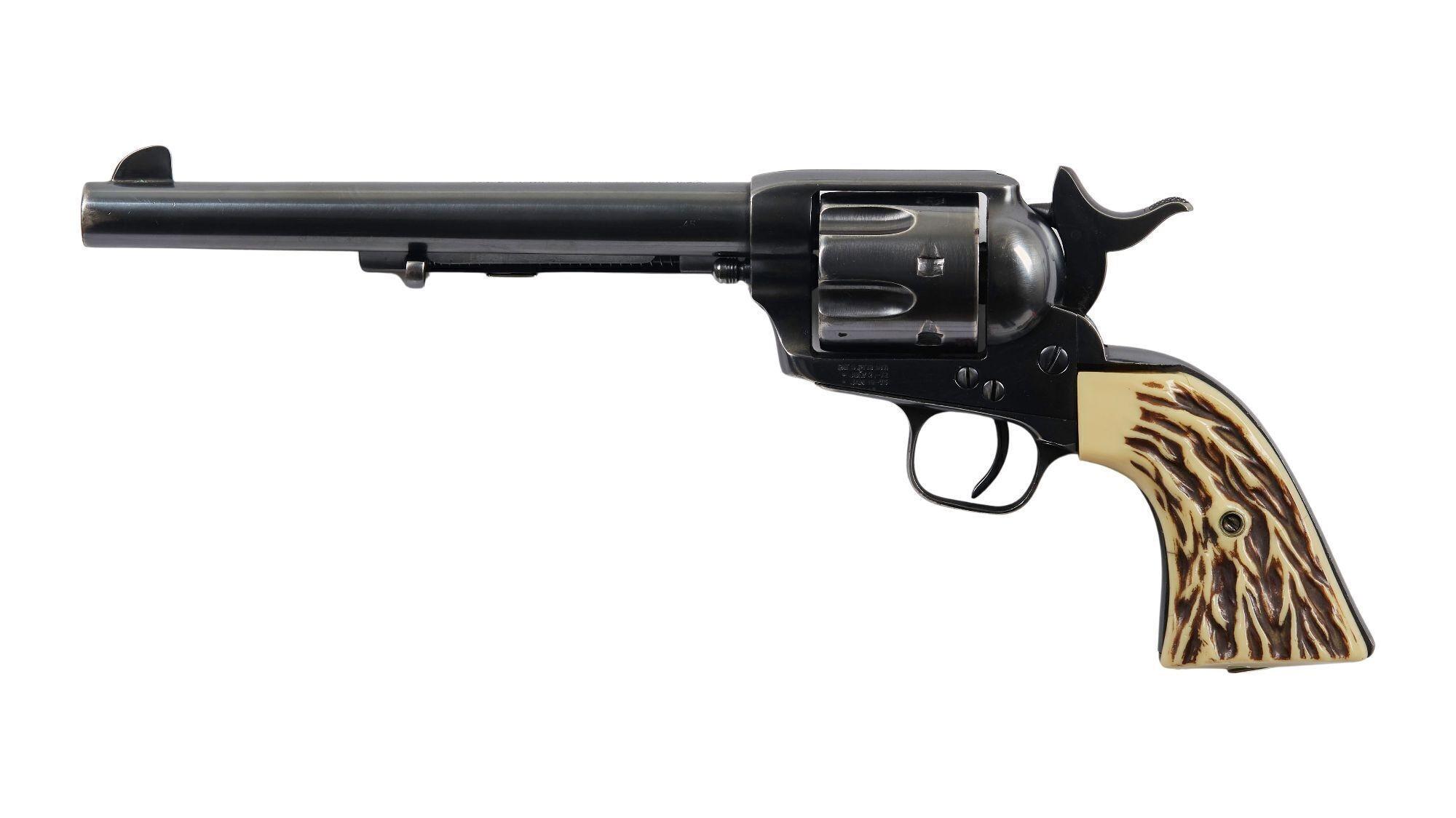 a black revolver with a horn grip on a white background .