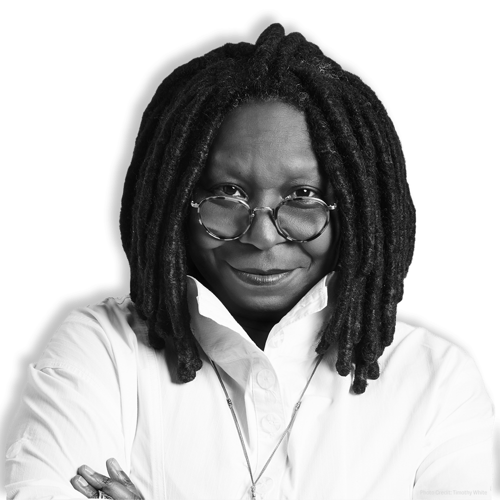 Black and white portrait of Whoopi Goldberg smiling, wearing glasses and a white shirt.