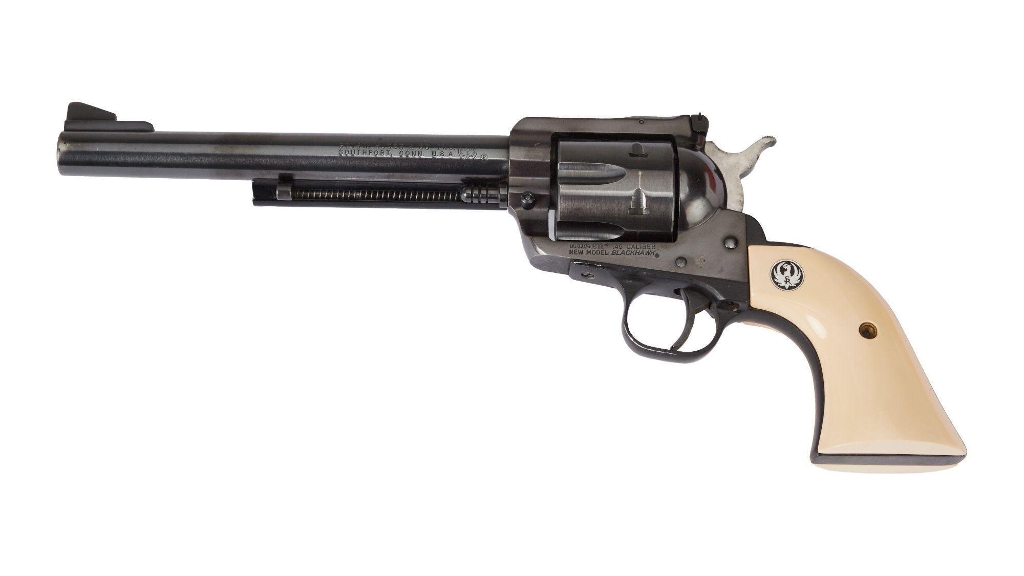 a revolver with a white grip on a white background .
