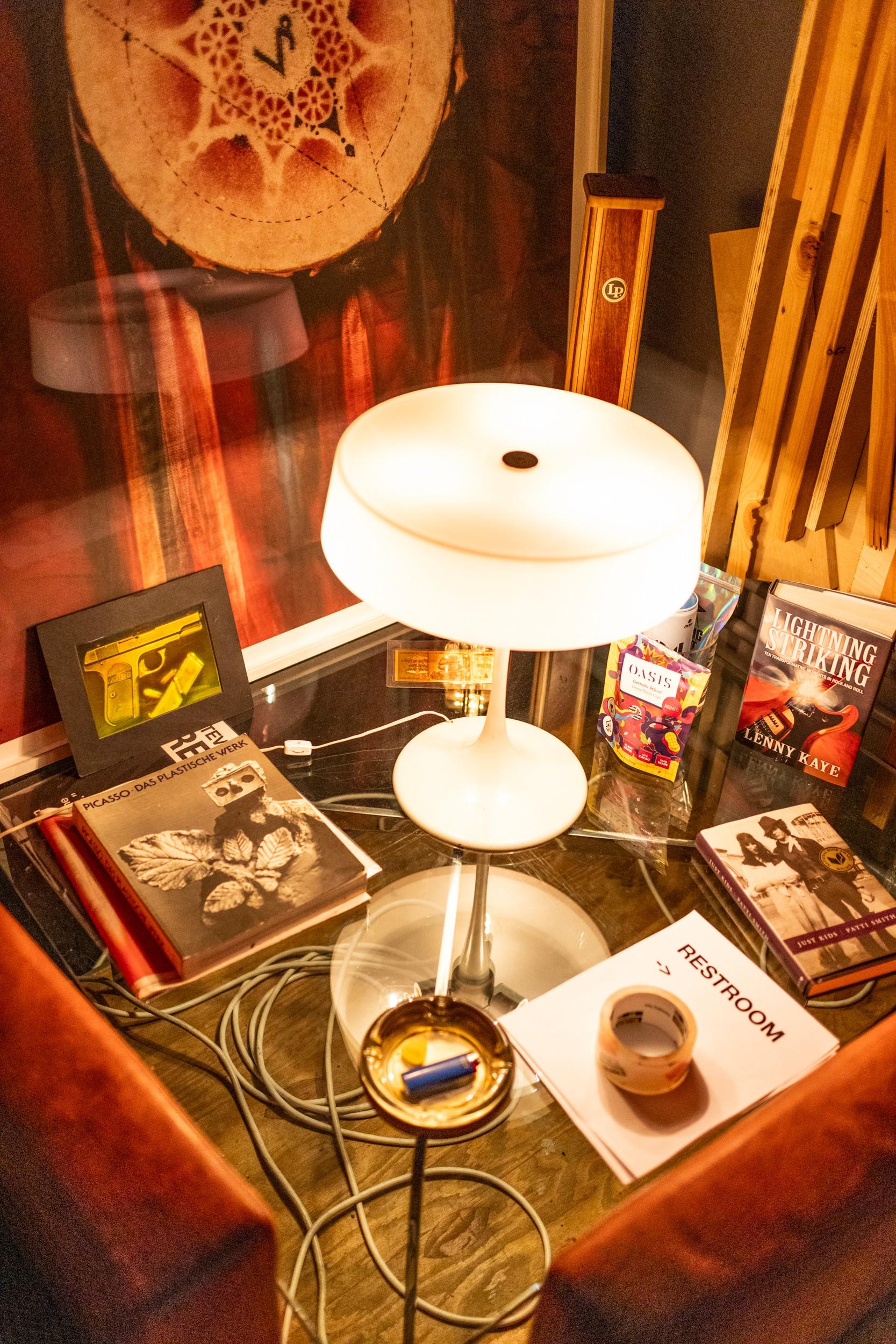 a book titled restroom sits on a table with other books