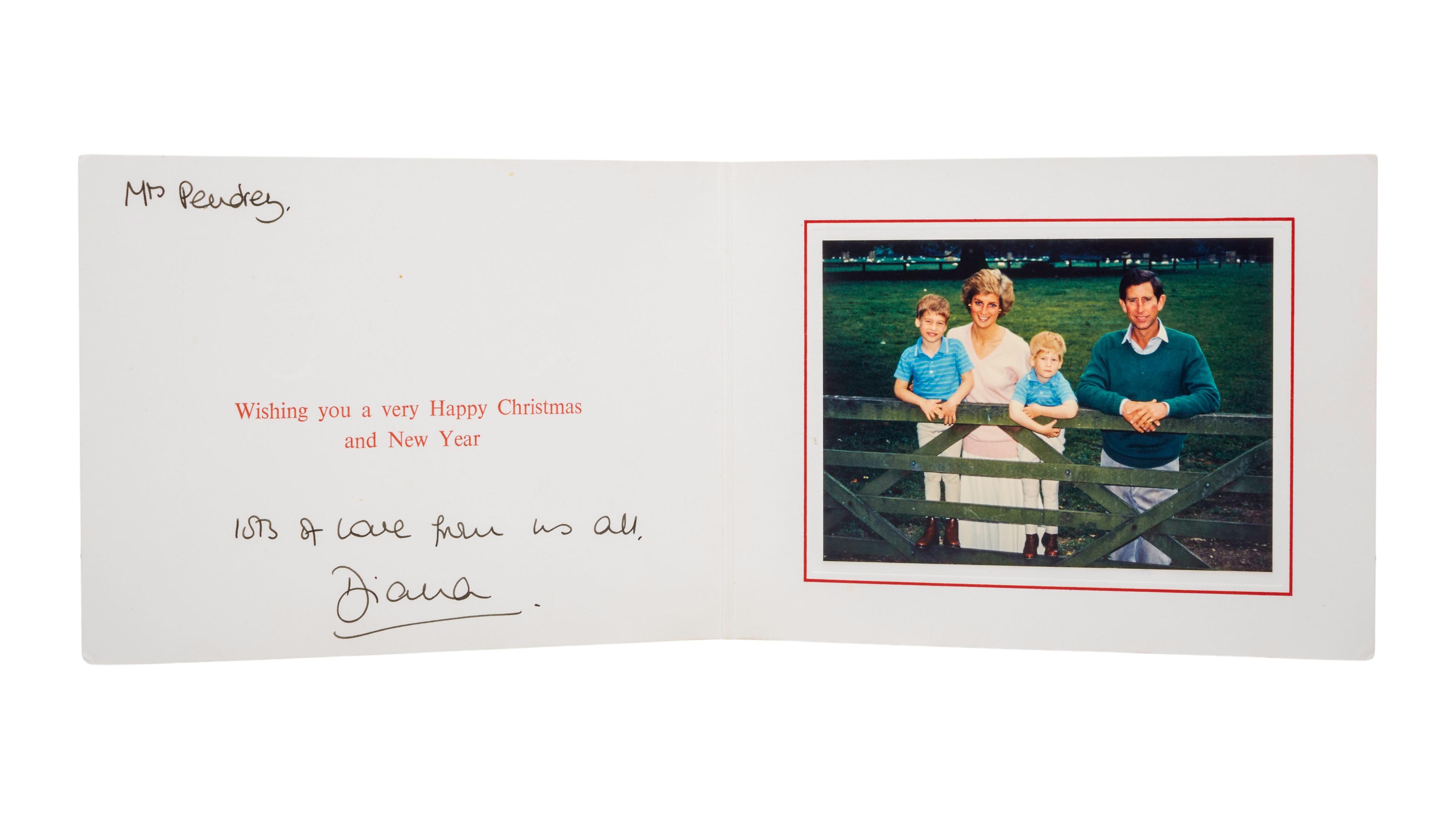 a christmas card with a picture of princess diana and her family on it .