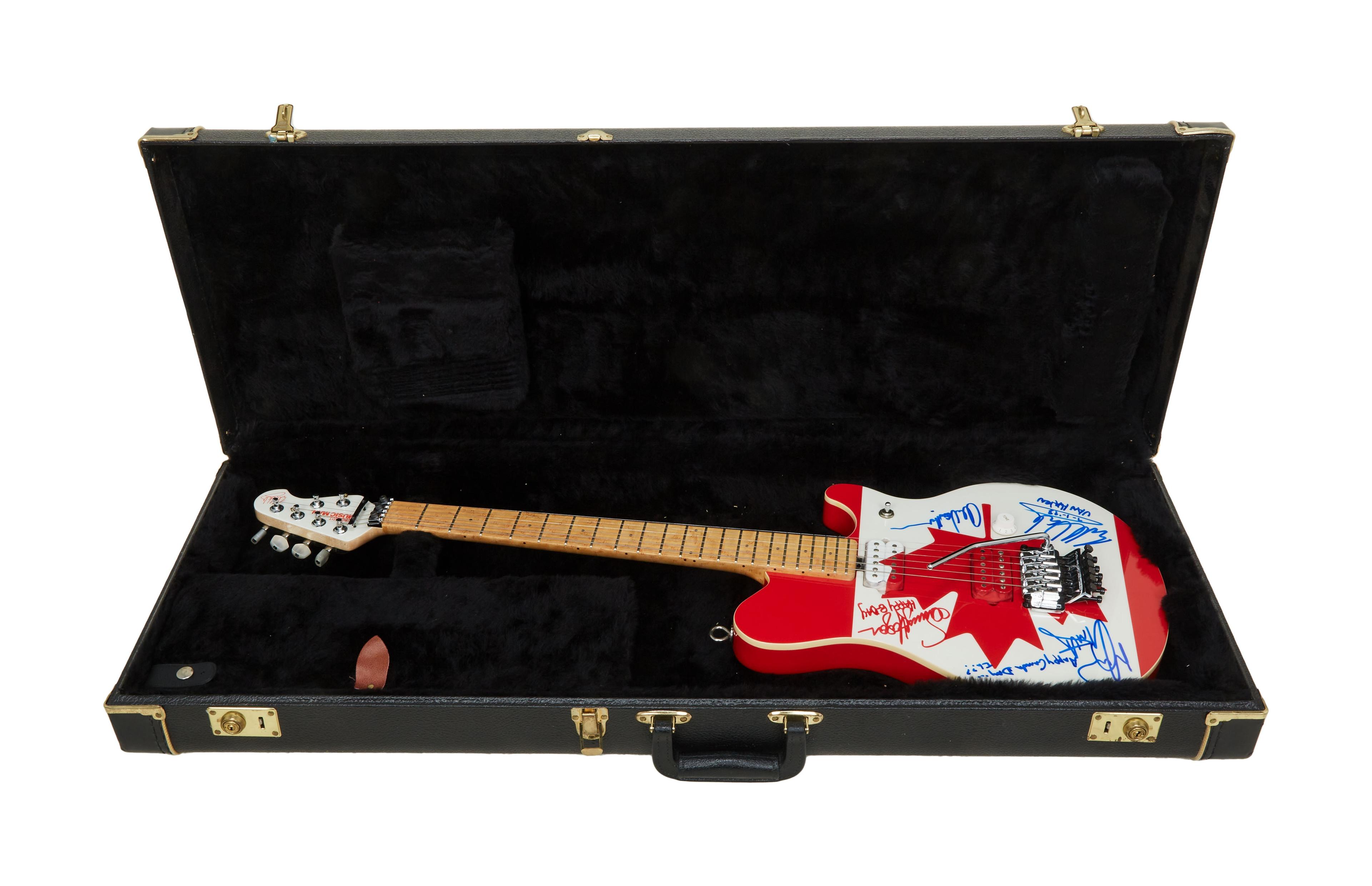 a red and white electric guitar is in a black case