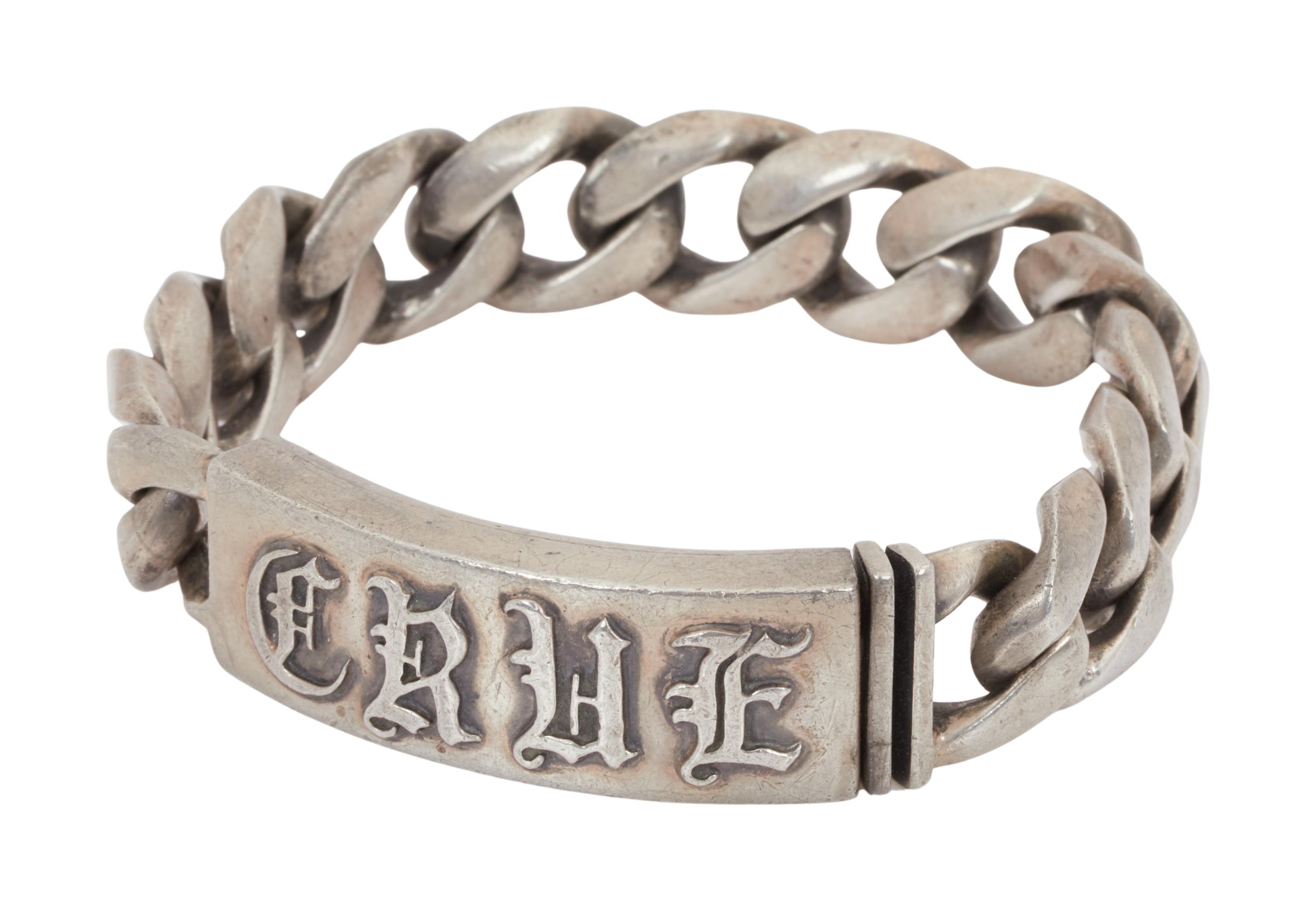 a silver tone bracelet that reads crue