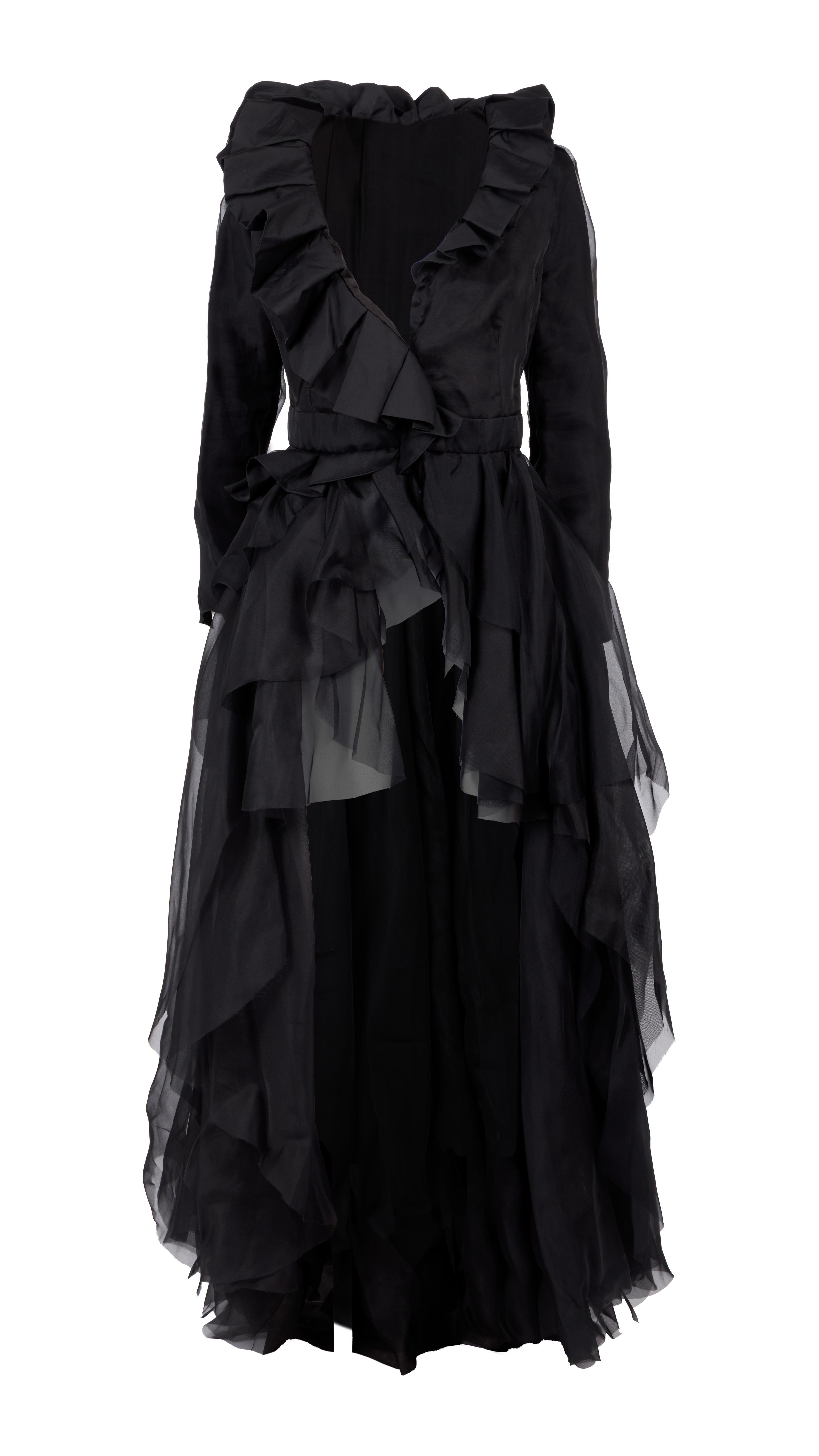 Black dress with a ruffled neckline, long sleeves, and a tiered, sheer flowing skirt.