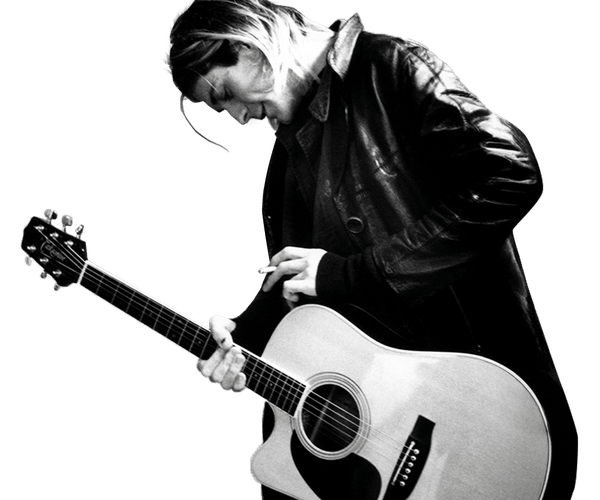 a black and white photo of a man playing an acoustic guitar
