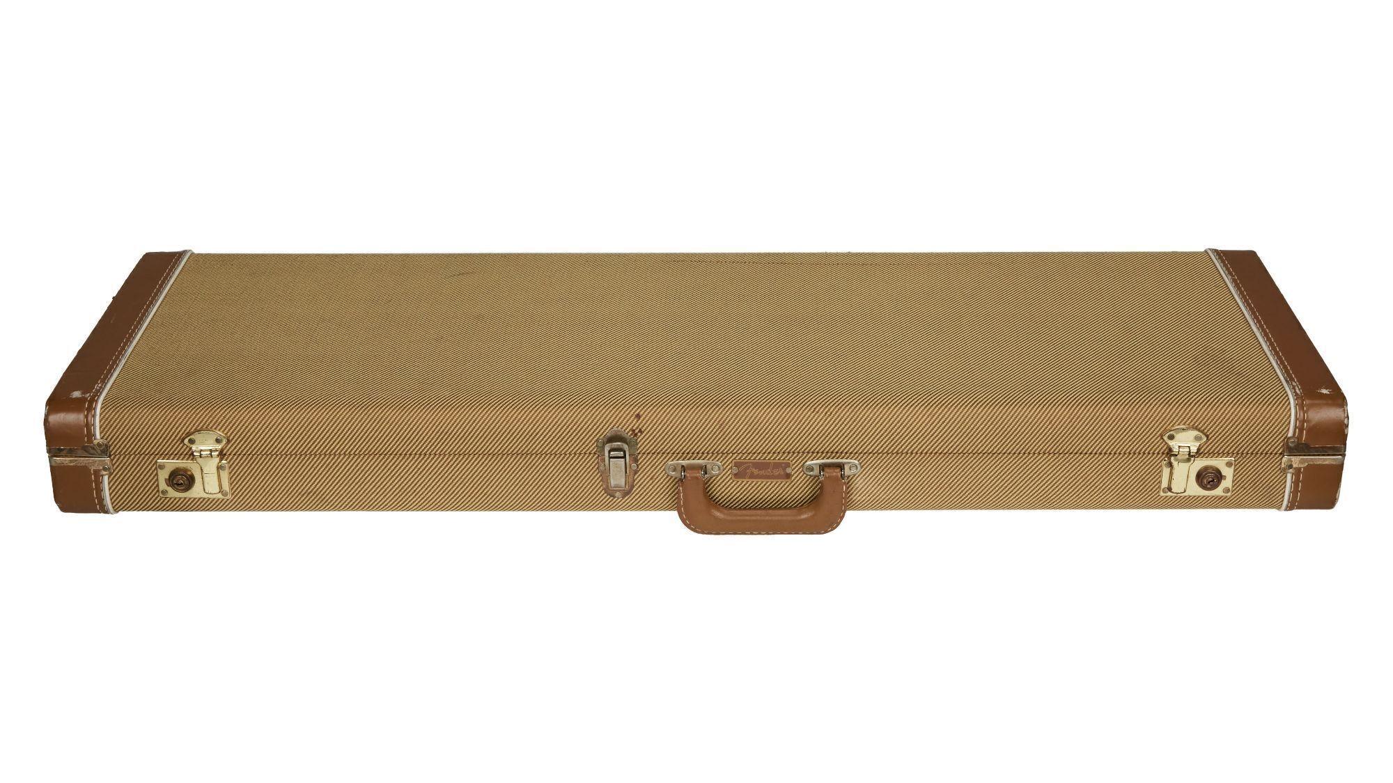 an empty guitar case with a brown handle on a white background .