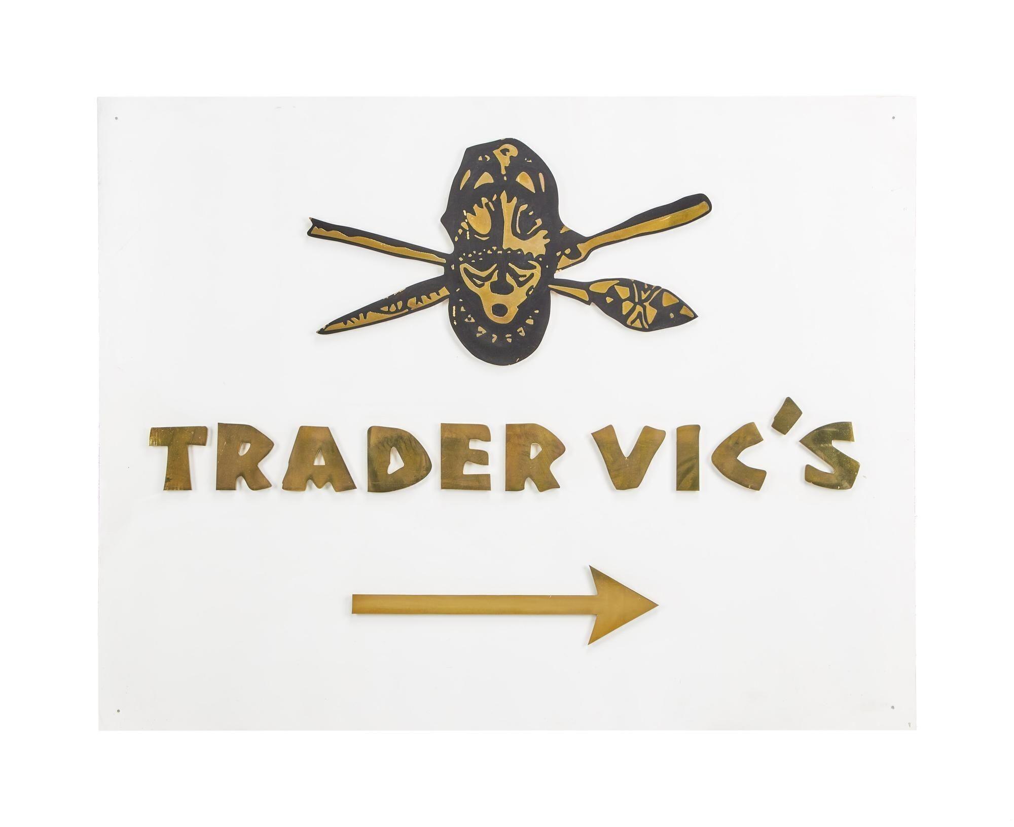a sign for trader vic 's with an arrow pointing to the right .