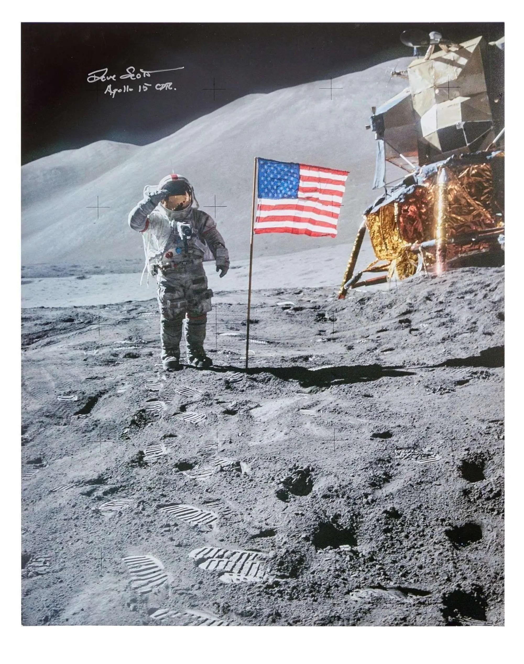 Astronaut Dave Scott salutes the American flag on the moon, with the lunar module in the background and footprints in the foreground.