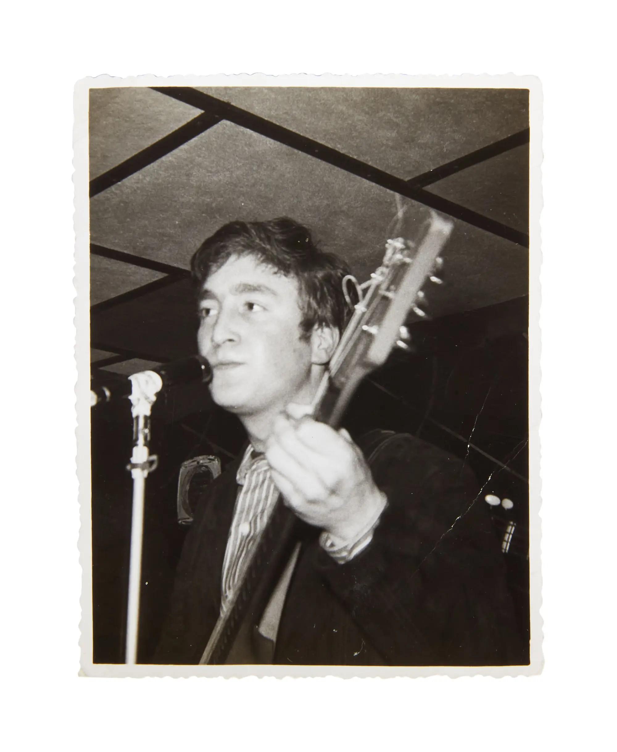 a black and white photo of john lennon