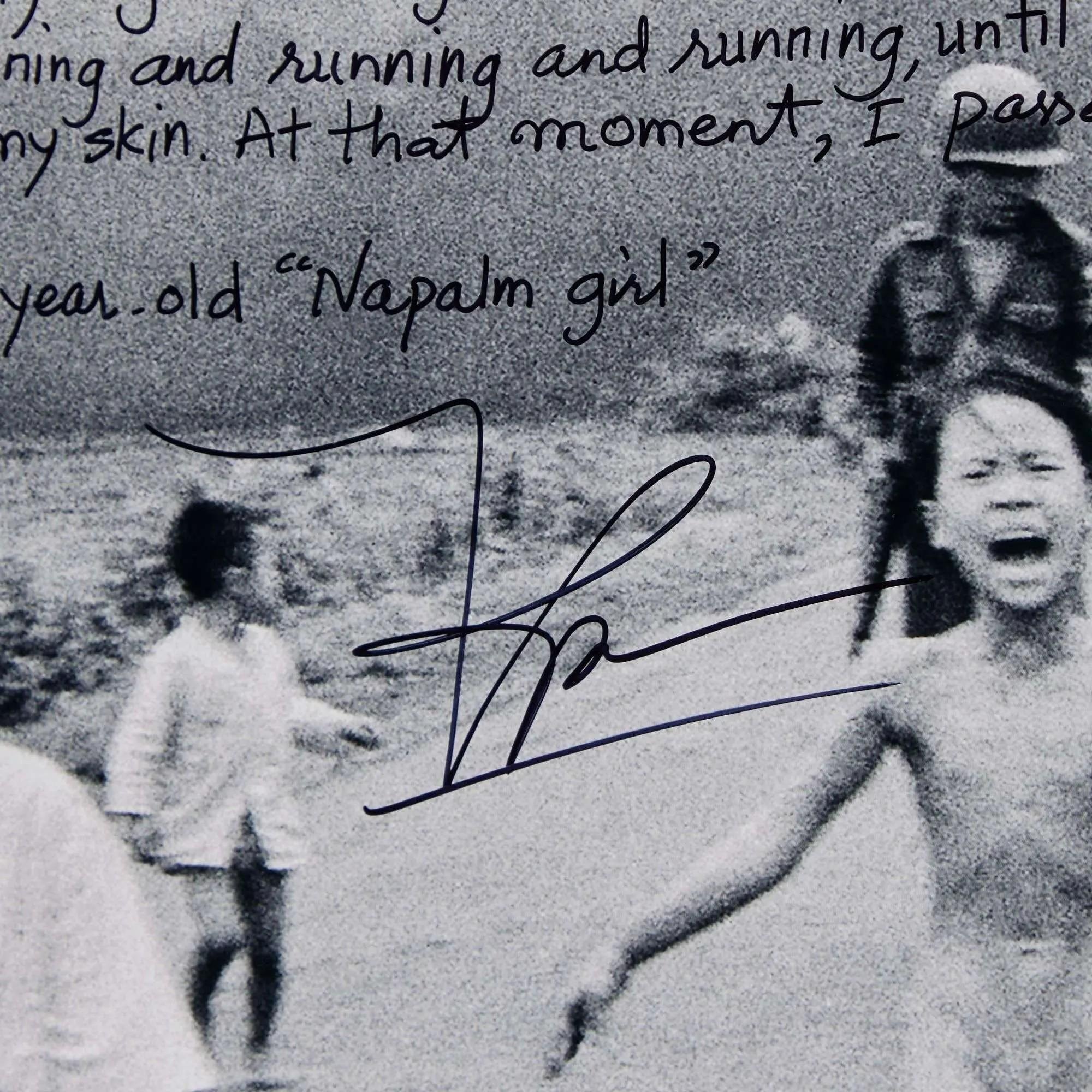 Black and white photo of the screaming "Napalm girl" running, with handwritten text and a signature overlaid.