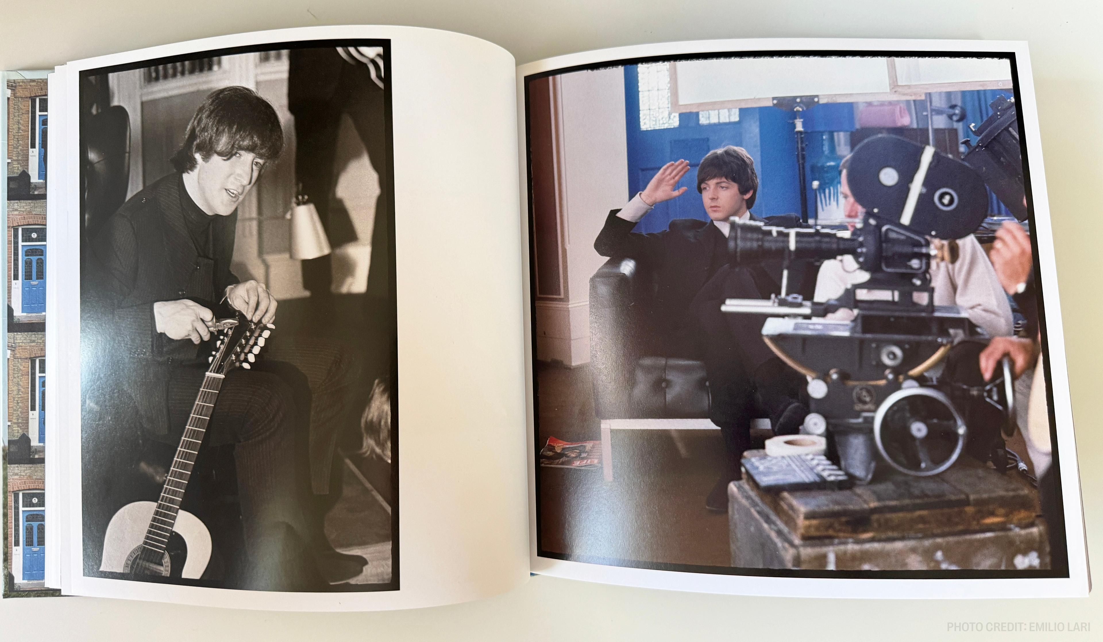 a book is open to a page with a picture of a man playing a guitar .