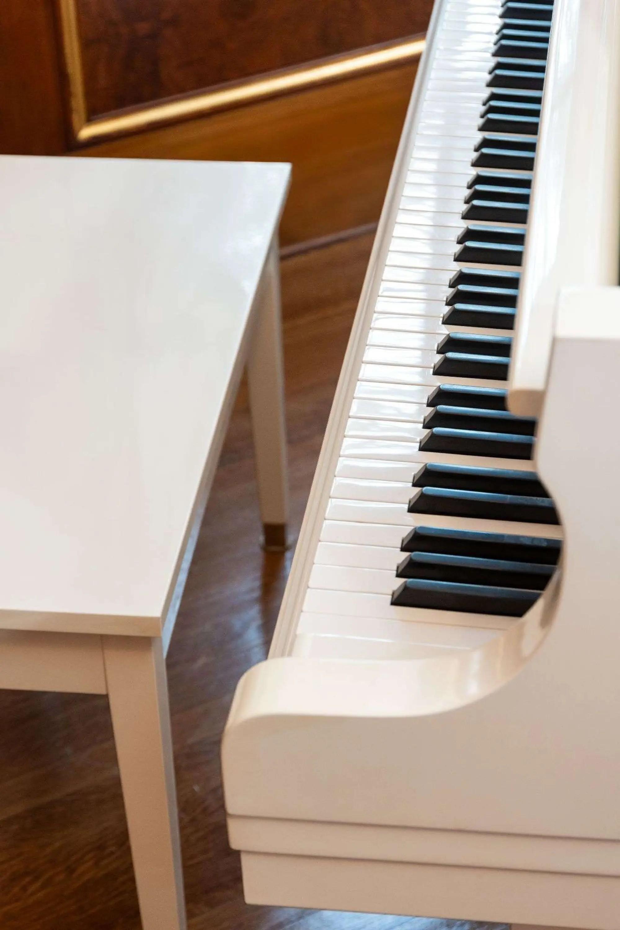 a white K. Kawaii Grand Piano and Bench in the home of whoopi goldberg