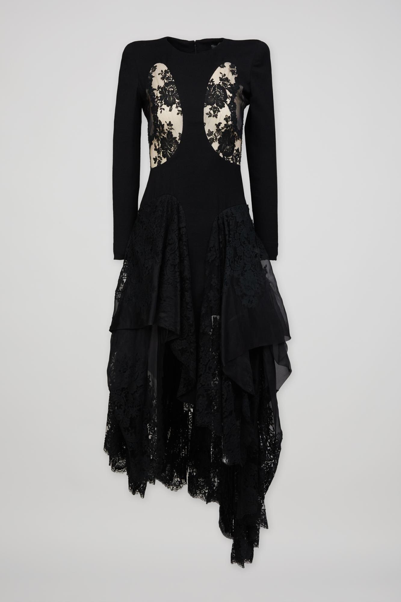 a black lace dress with long sleeves and a ruffled skirt