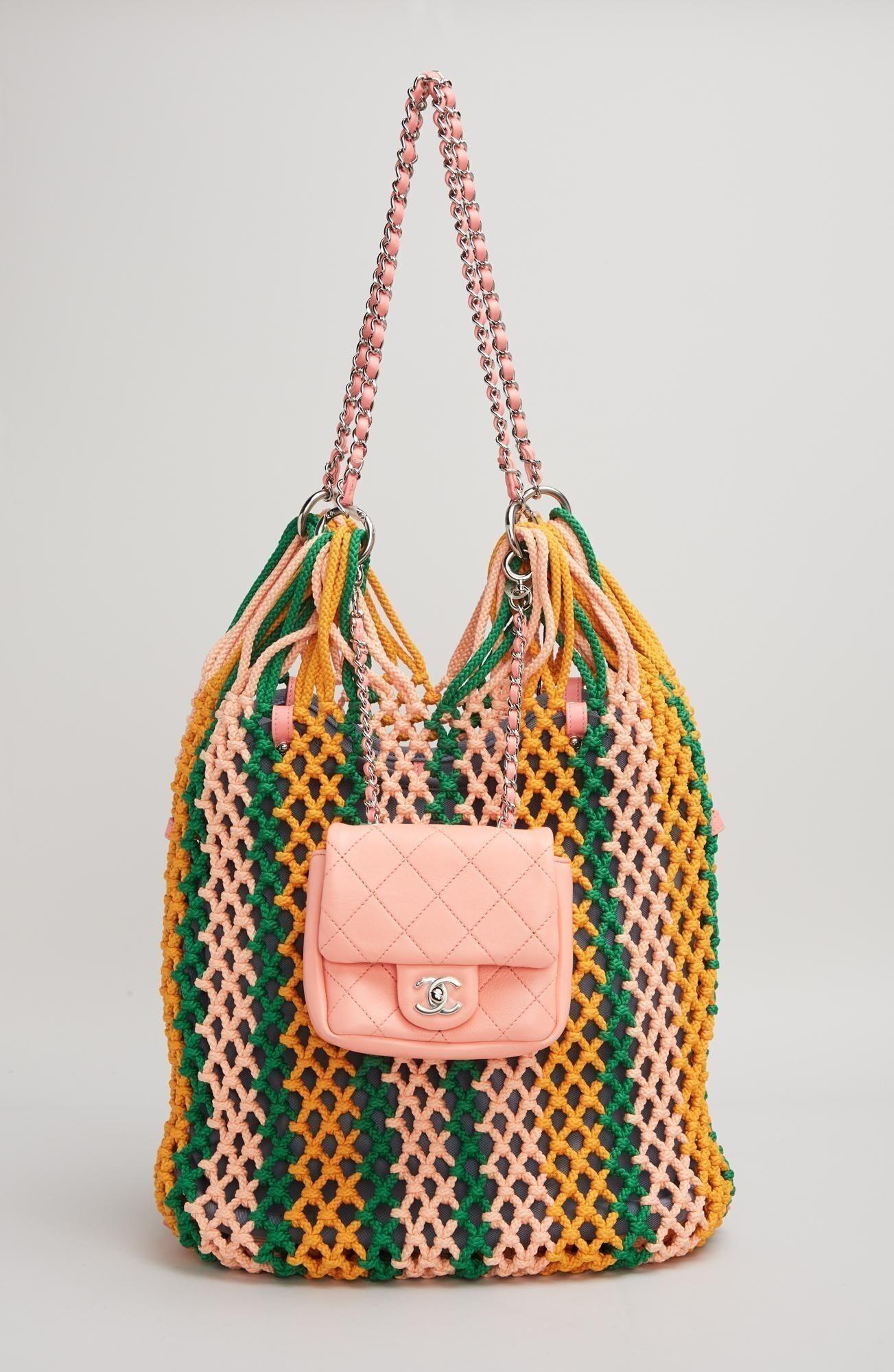 a colorful bag with a pink chanel purse attached to it
