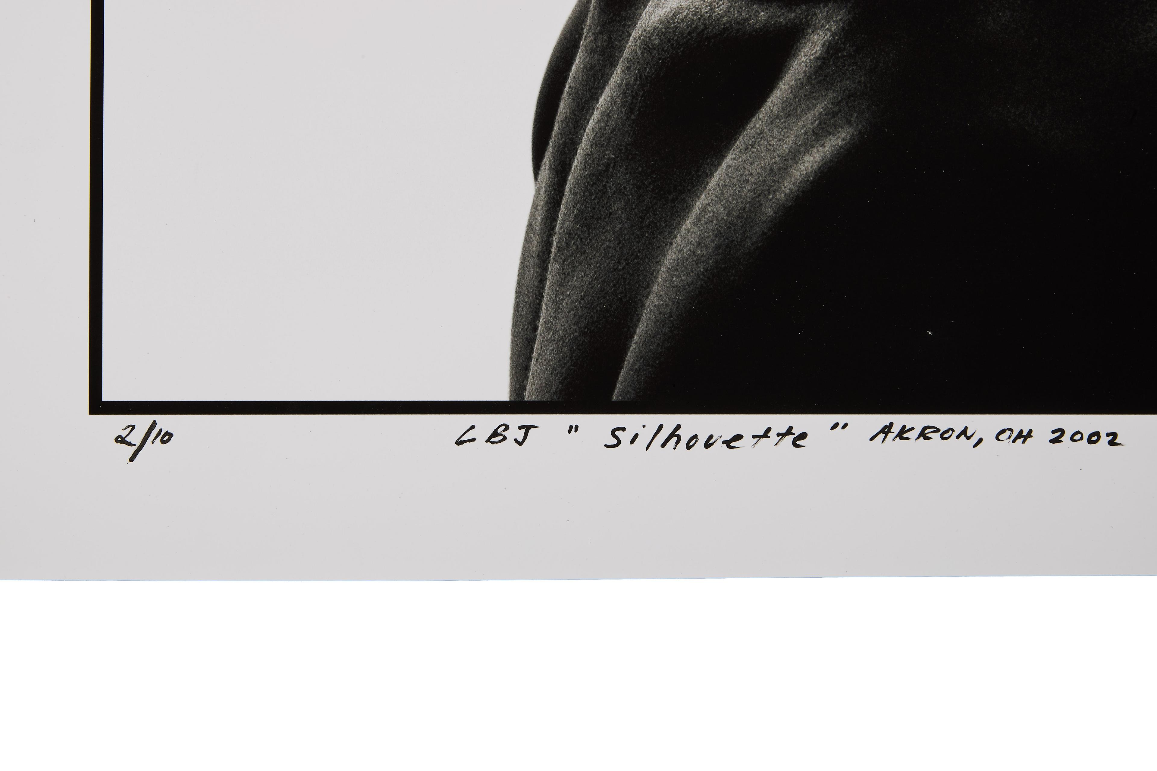 a close up of a black and white photo of a person 's silhouette .