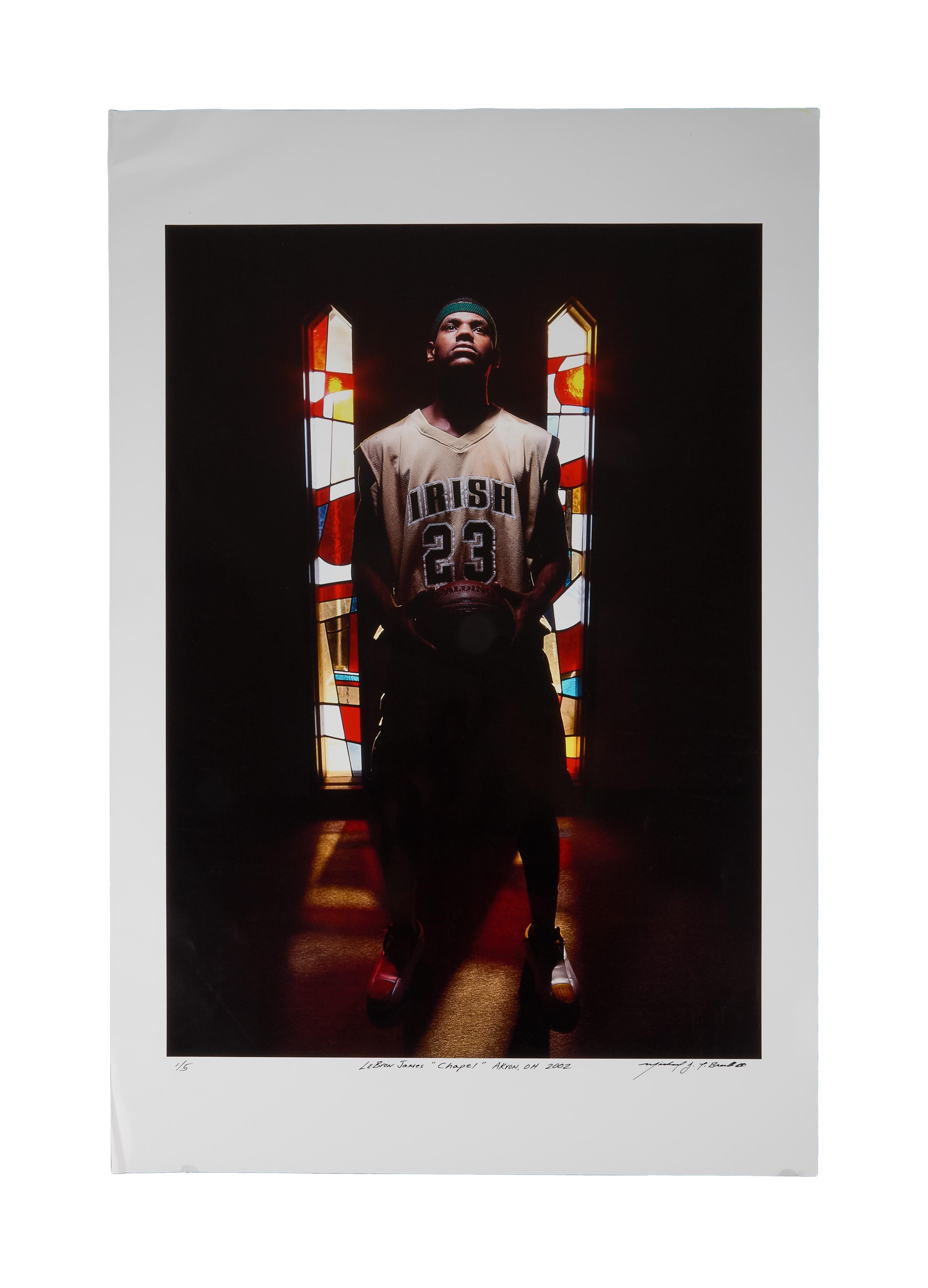 a man in an irish jersey stands in front of a stained glass window