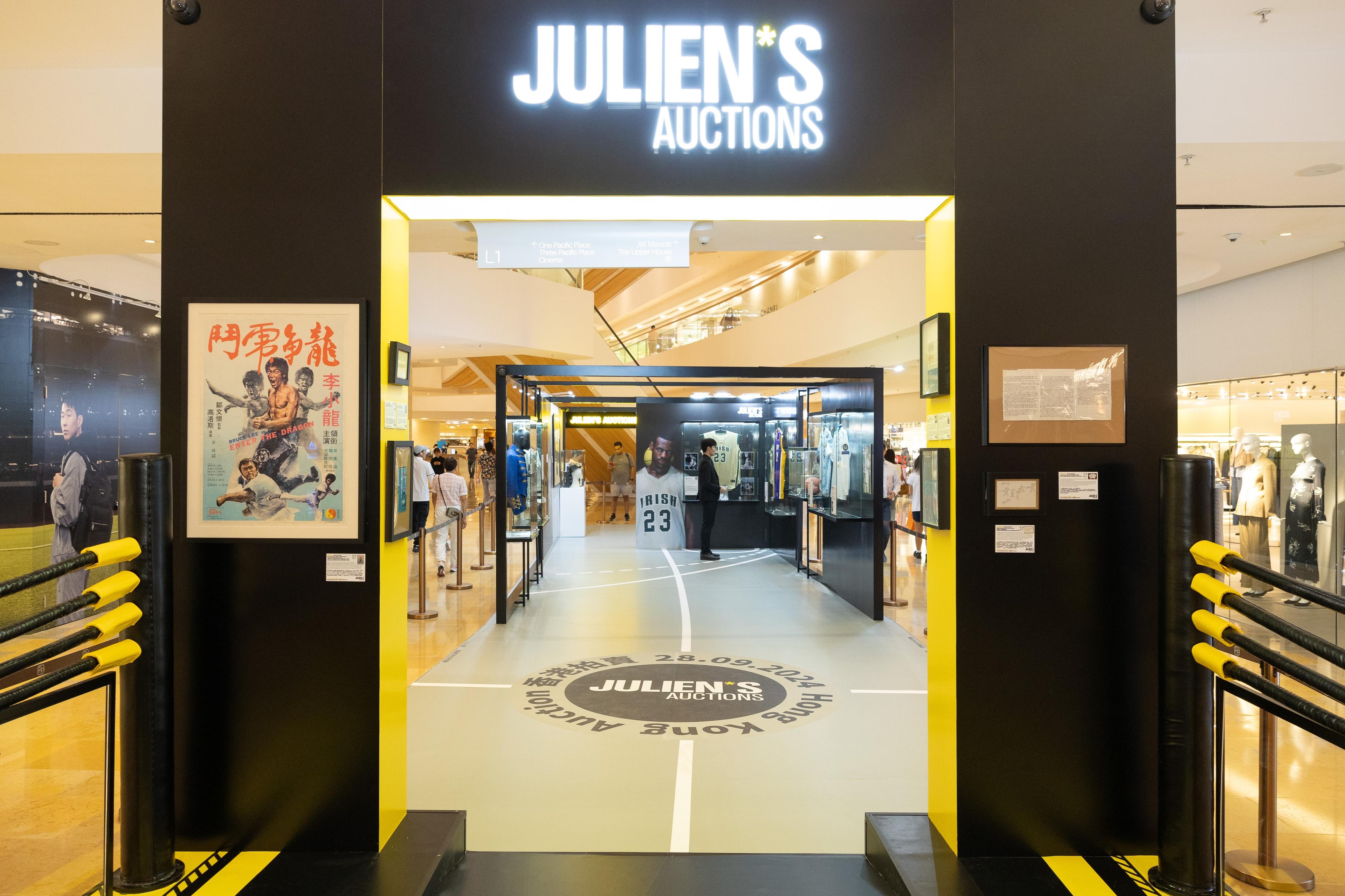 the entrance to julien 's auctions in a shopping mall .