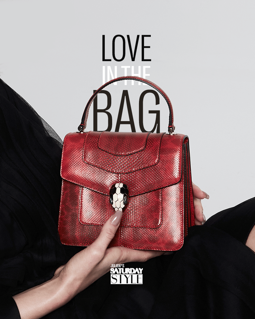 a woman holding a red bag that says love in the bag
