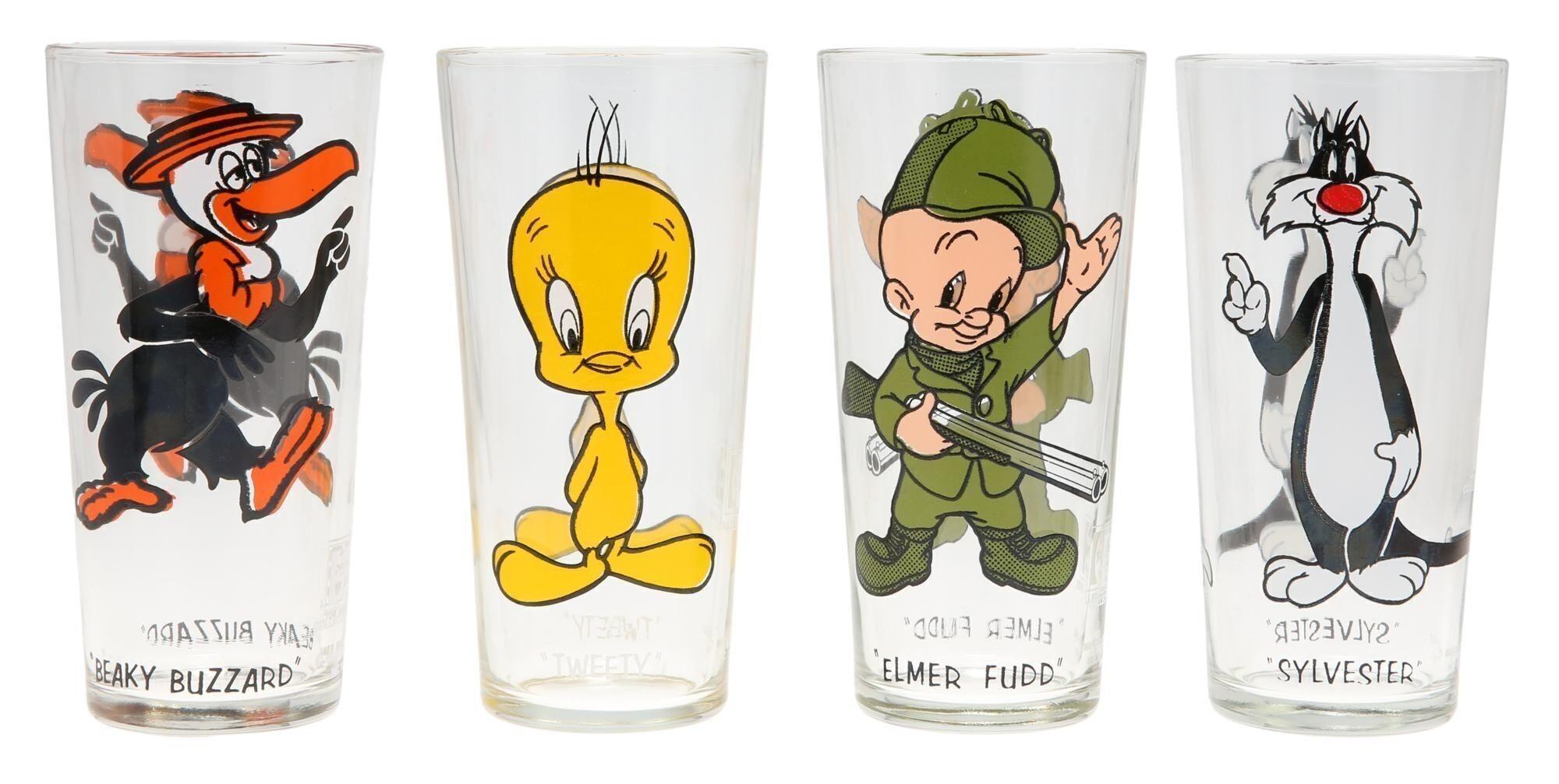 a set of four glasses with cartoon characters on them .