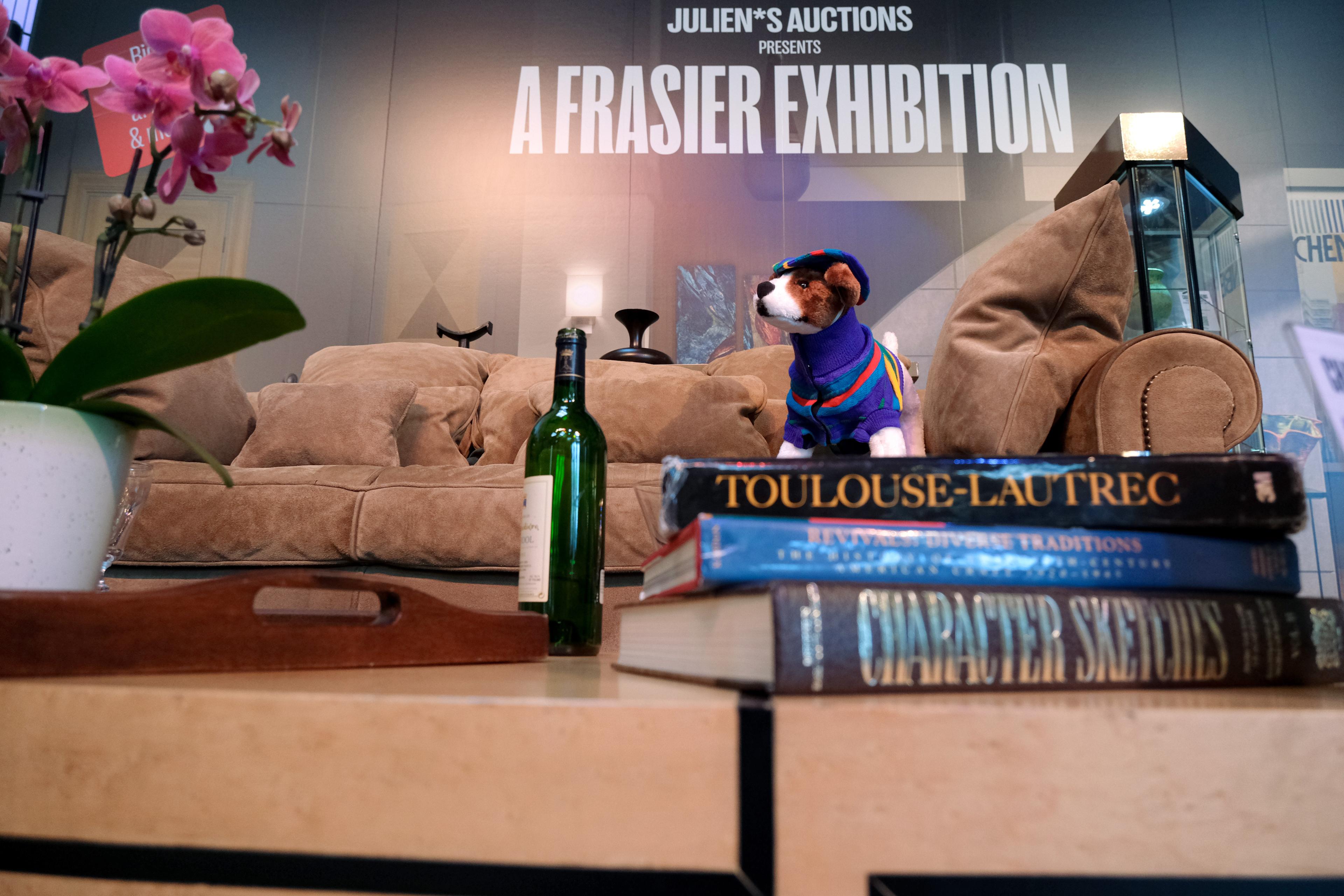a close up of books stacked on a coffee table in front of a sofa