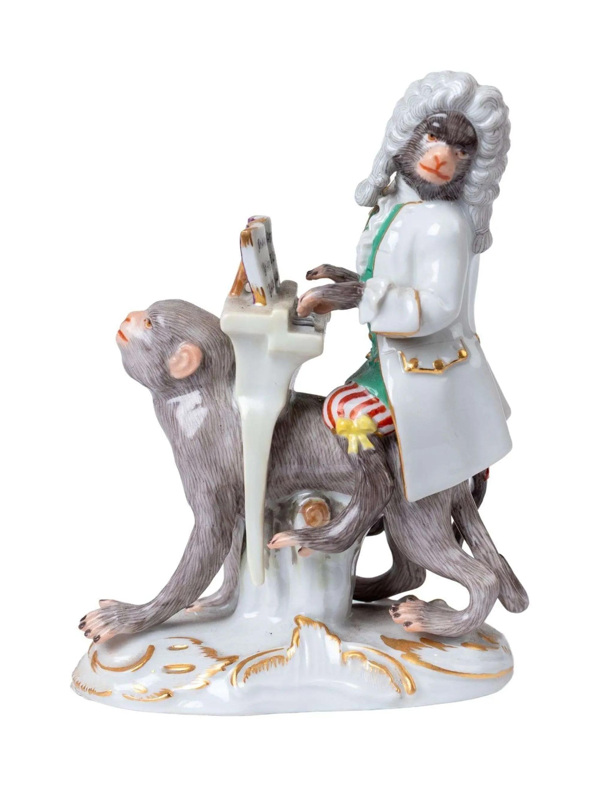 a meissen monkey band figurine playing a piano while sitting on another monkey