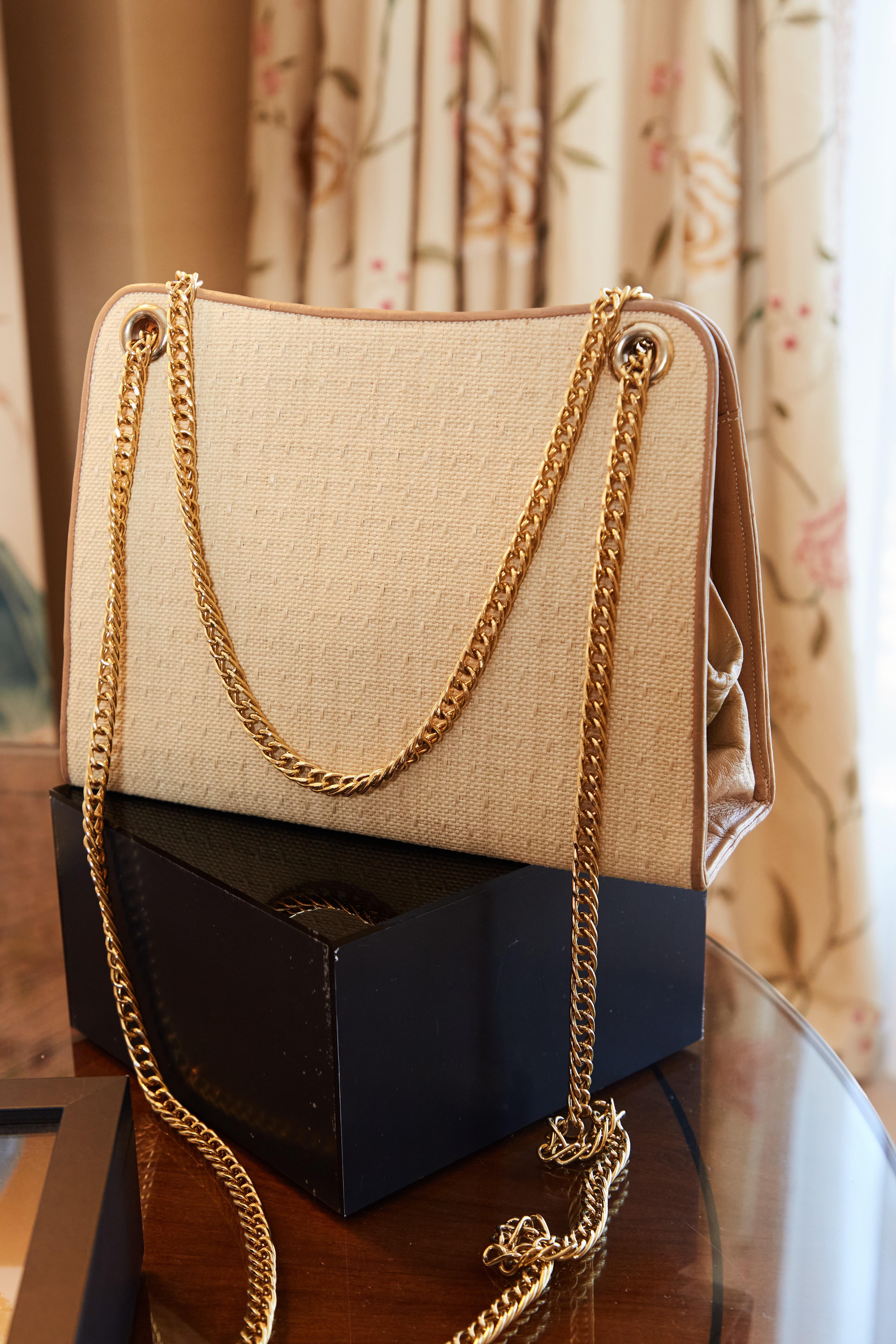 a purse is sitting on top of a black box on a table