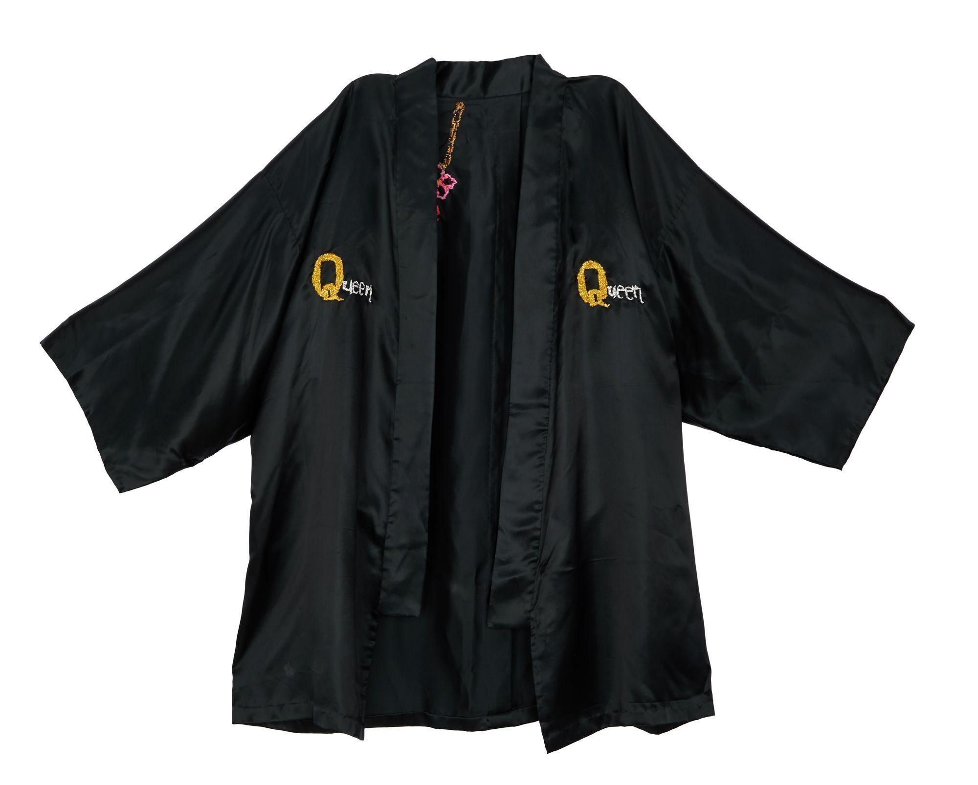 Lot #49. Freddie Mercury | Personally Owned Kimono a black kimono with the word queen embroidered on it .