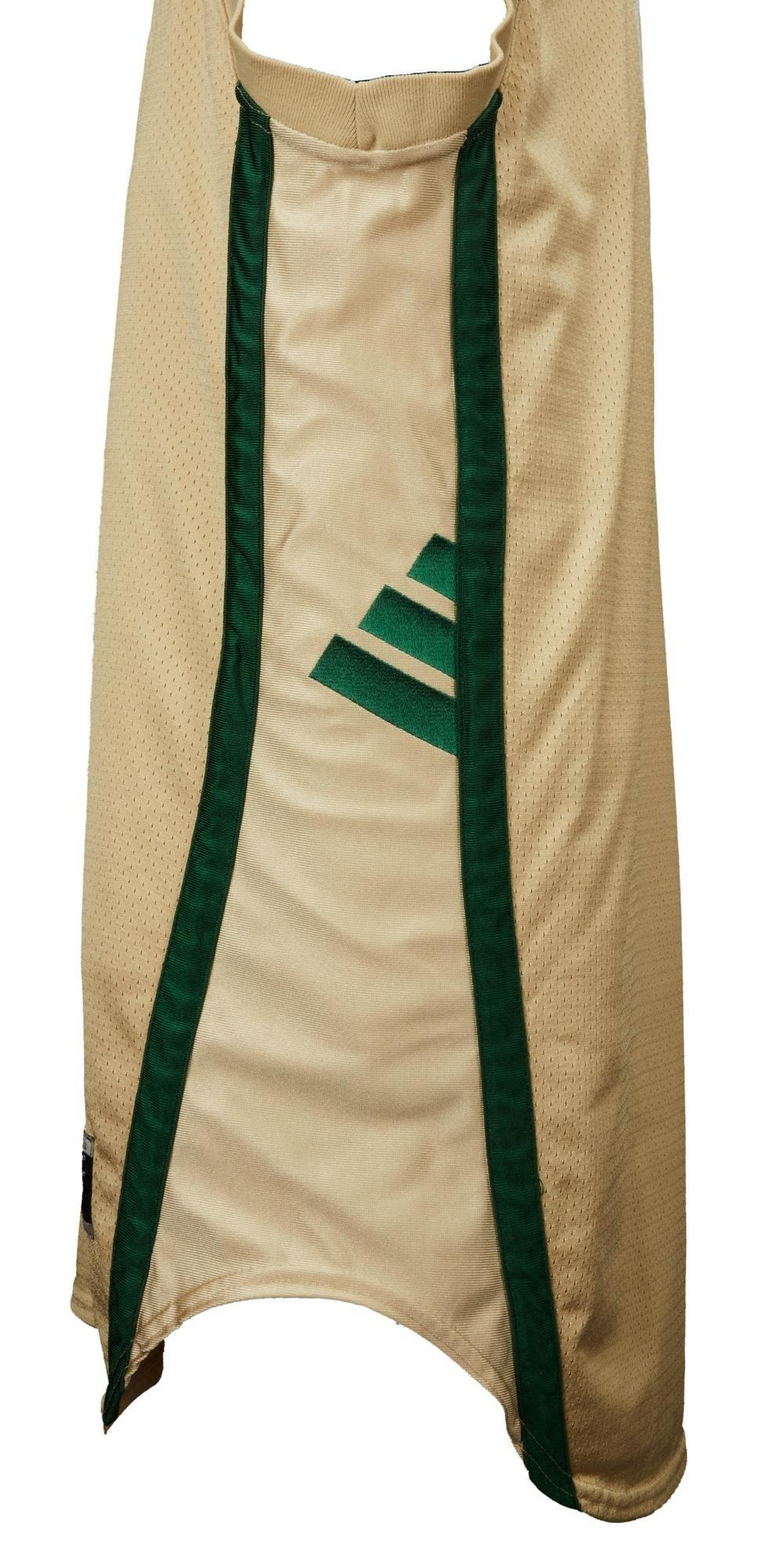 the back of a tan and green adidas jersey