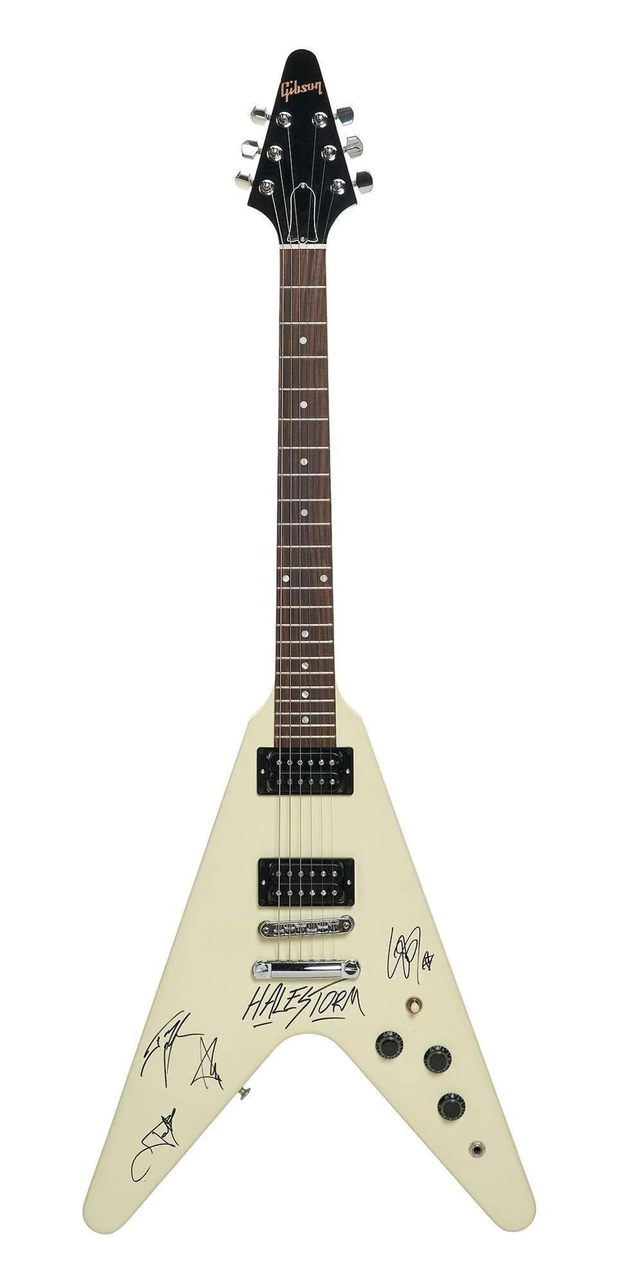 Lot #5. Halestorm | Band-Signed Gibson Flying V 80s Electric Guitar Classic White A cream Gibson Flying V electric guitar signed by Halestorm and other signatures.