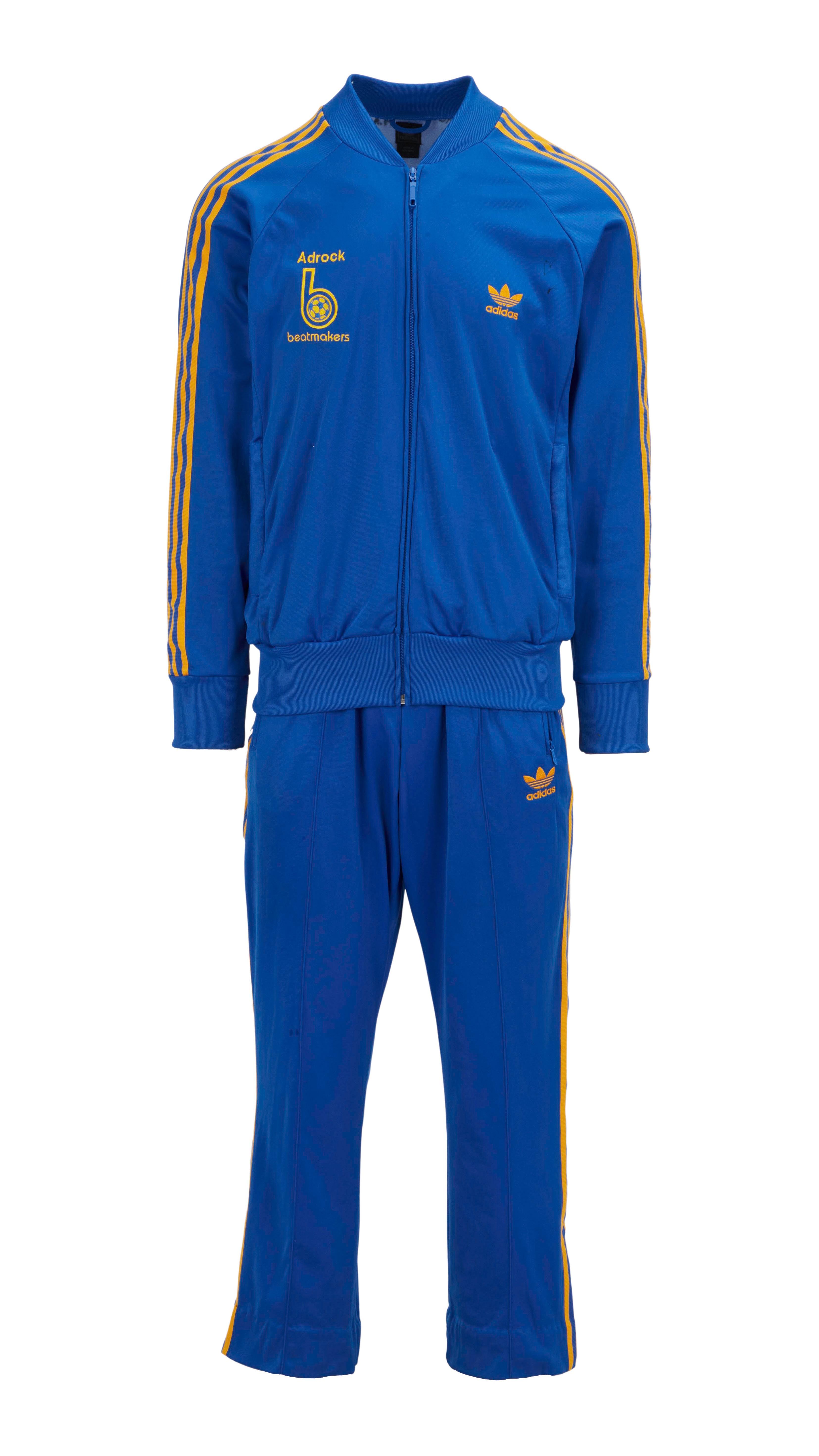 a blue adidas tracksuit with yellow stripes on the sleeves