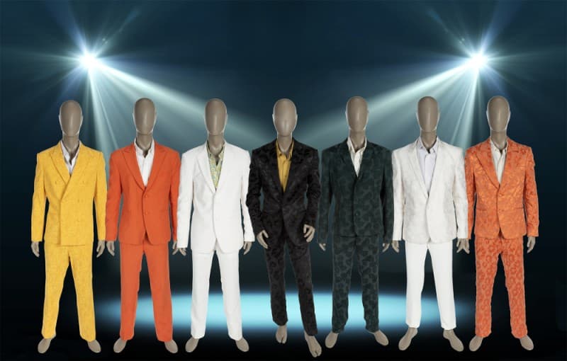 a row of mannequins wearing different colored suits