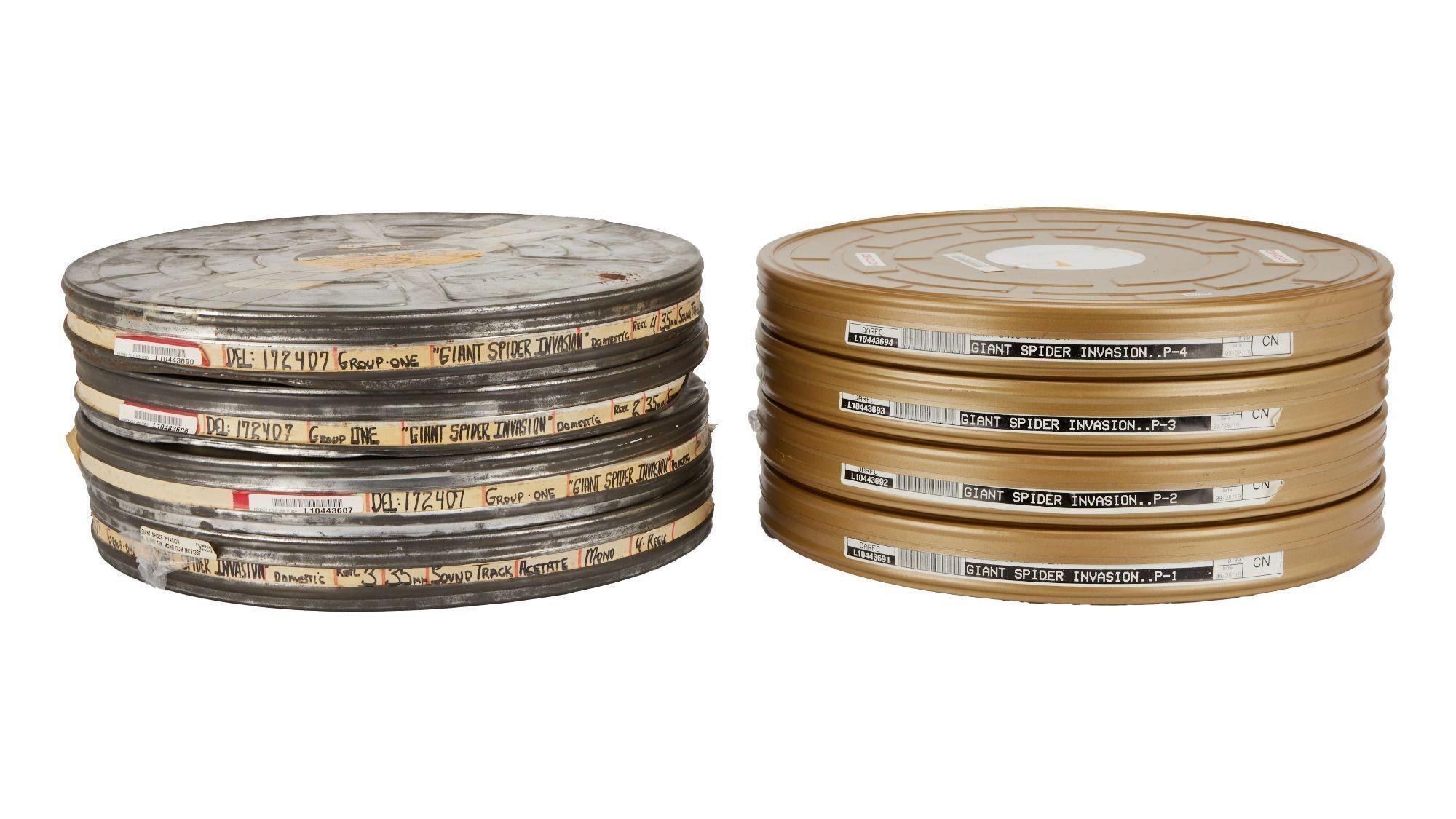 two stacks of film cans are sitting next to each other on a white background .