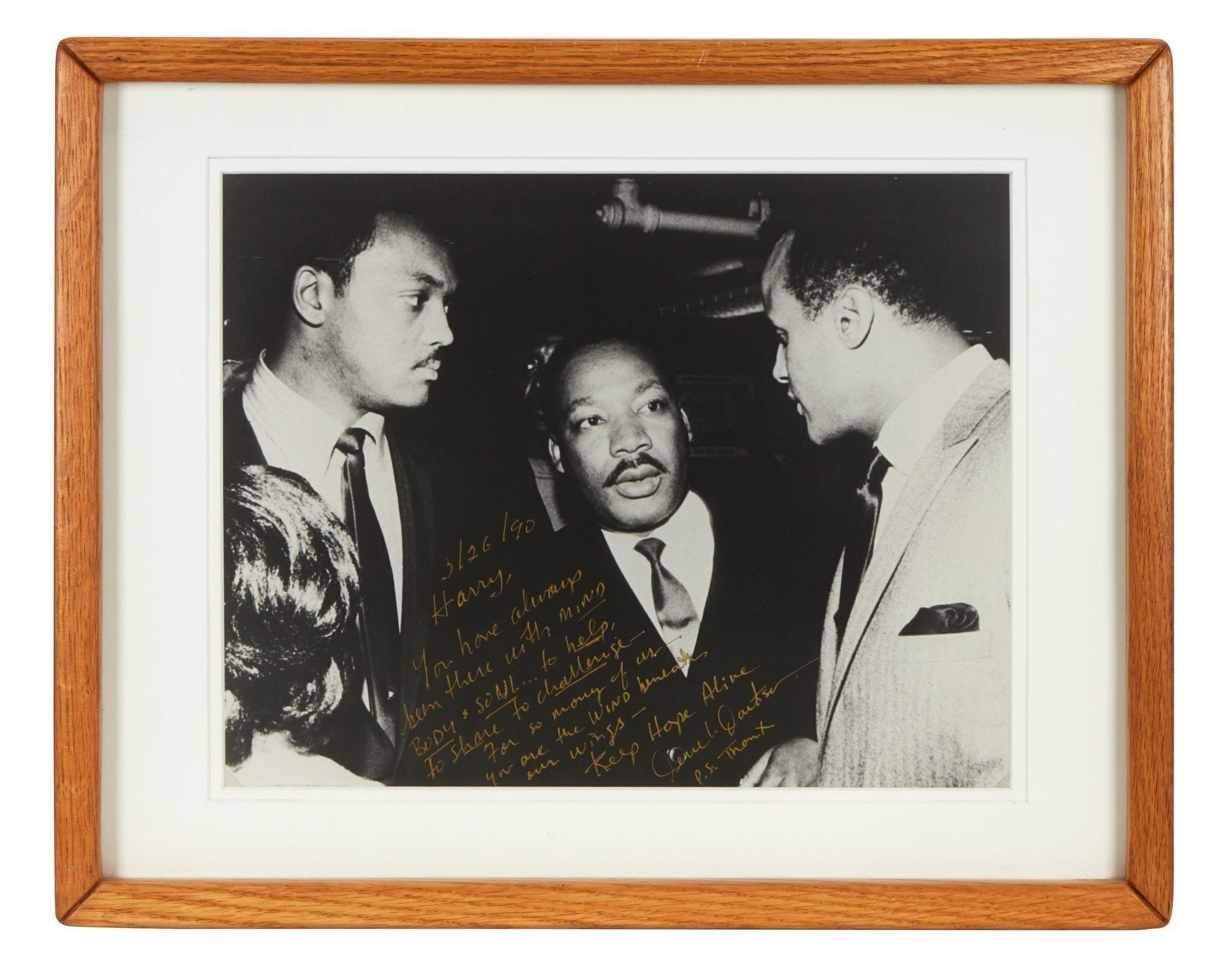 Lot #80. Harry Belafonte | Jesse Jackson Inscribed Photograph With Dr. Martin Luther King Jr. a black and white photo of three men standing next to each other in a wooden frame .
