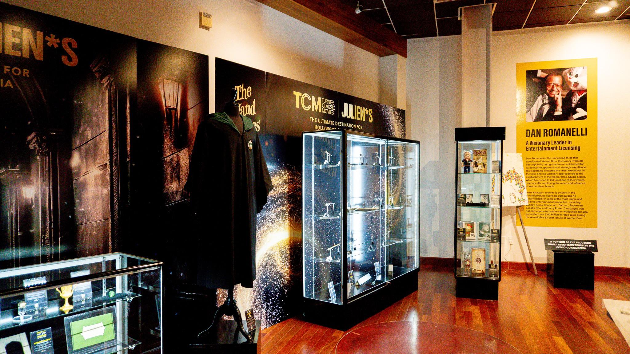 a museum with a lot of display cases and posters on the wall .