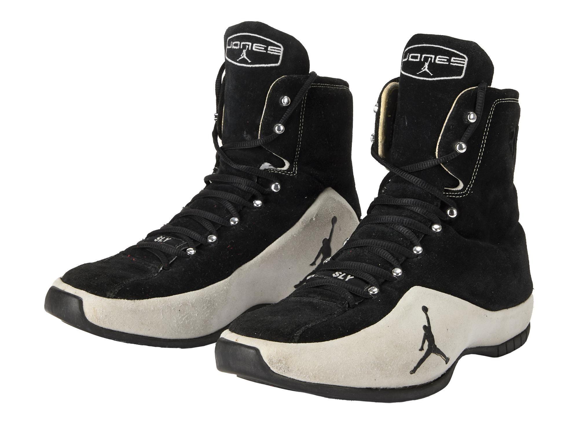 a pair of black and white jordan brand roy jones junior boxing shoes