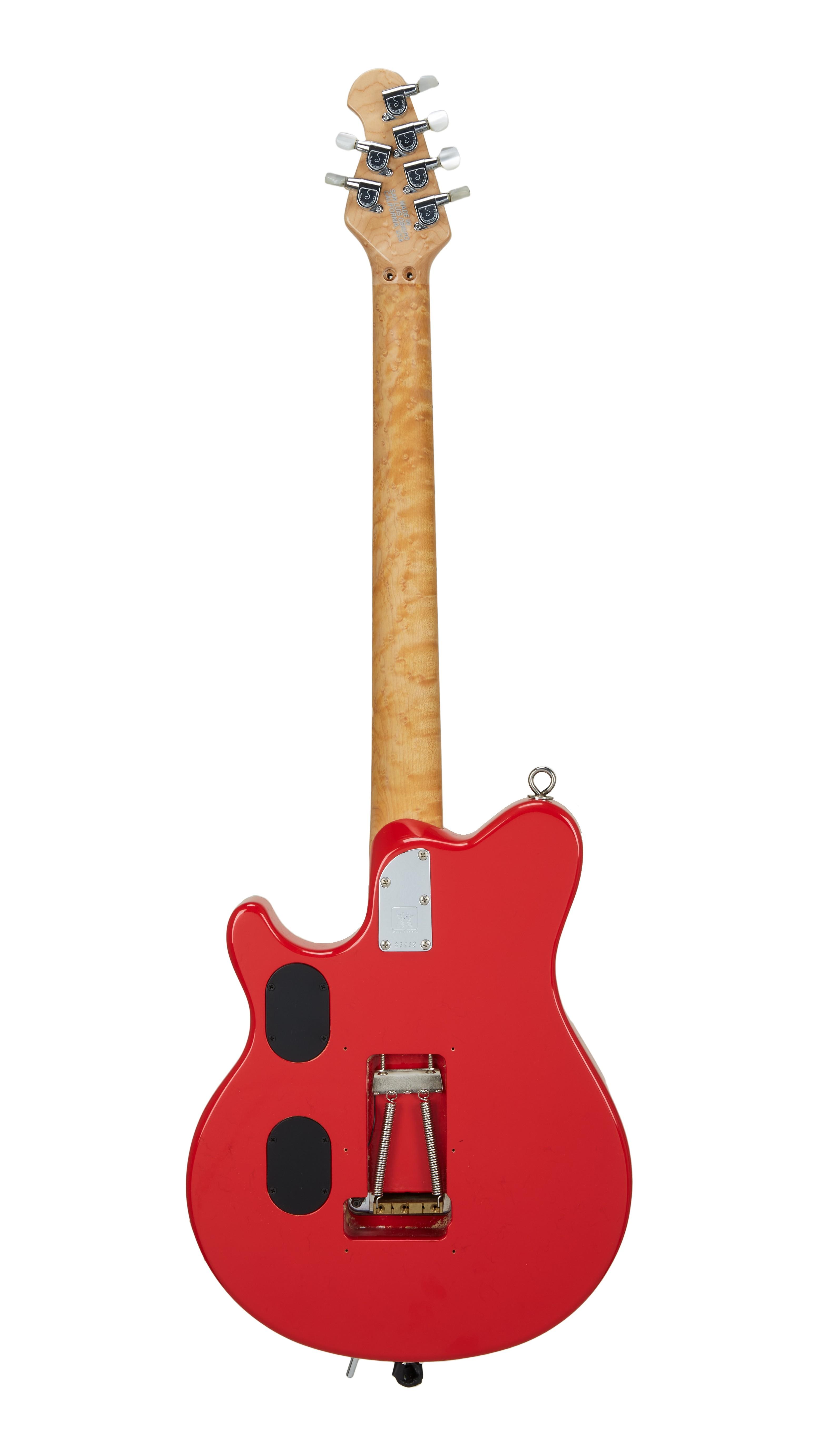 the back of a red electric guitar with a white background