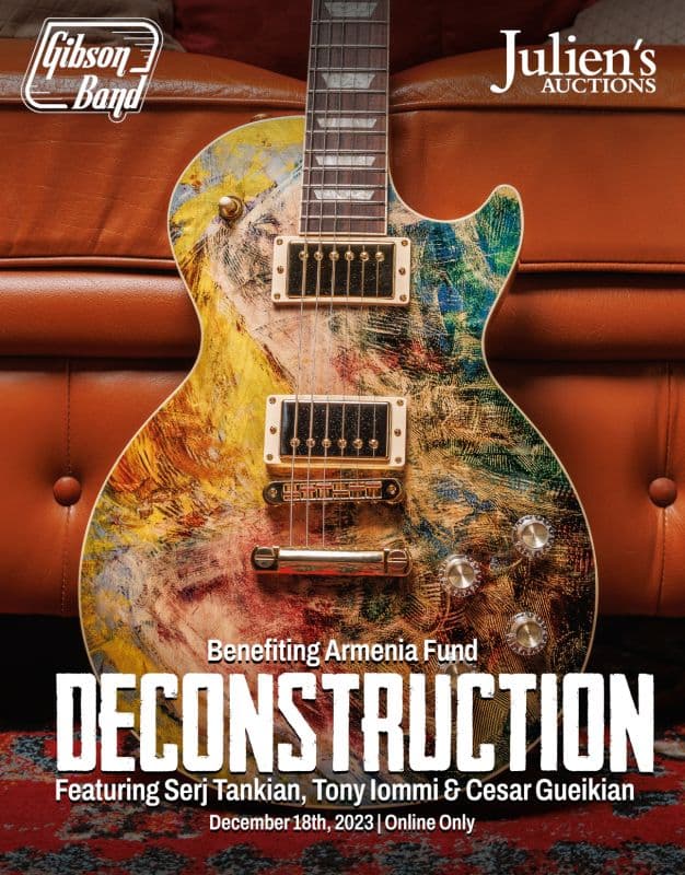 A poster for Julien's Auctions featuring a guitar