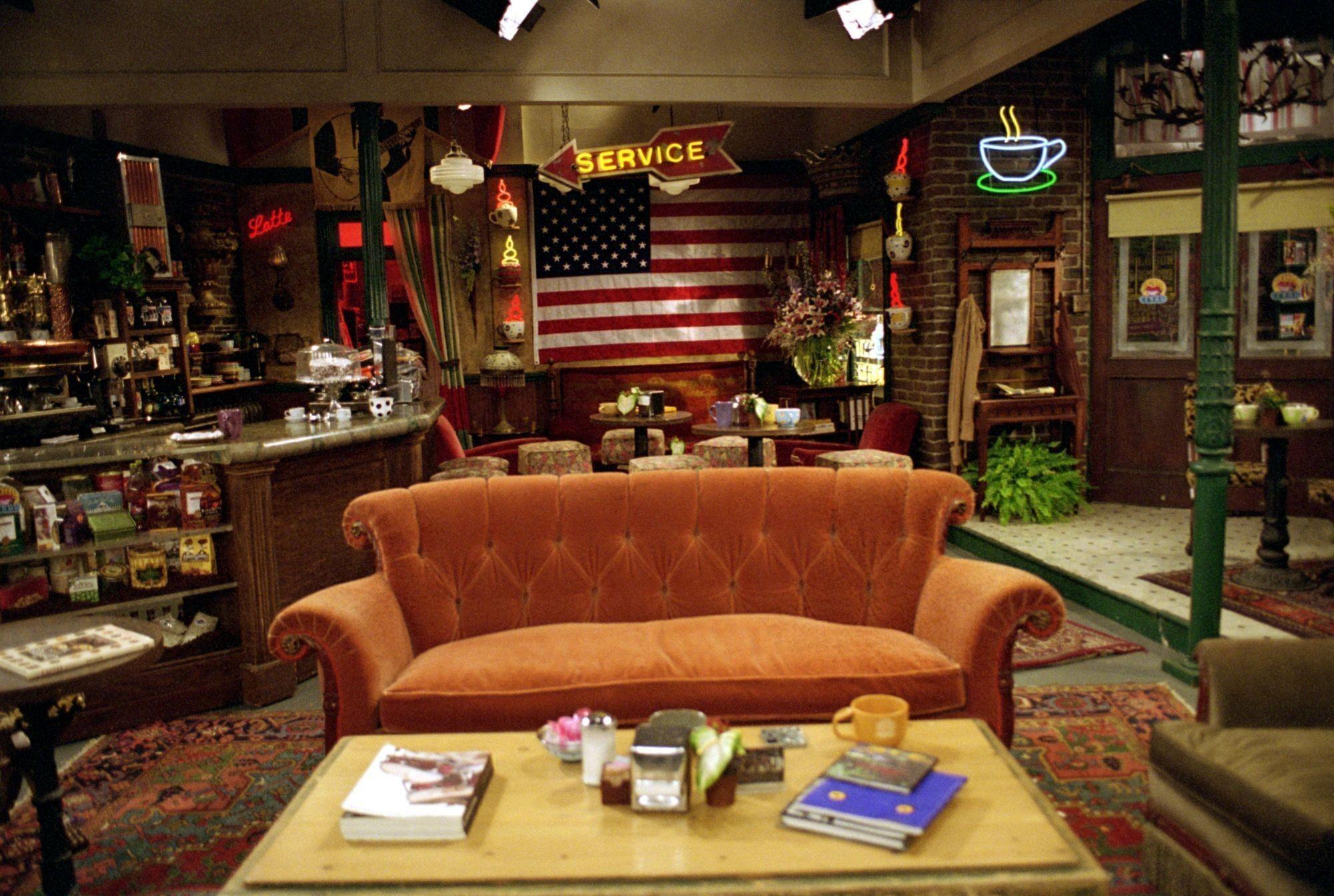 a living room with a couch , coffee table , and american flag .