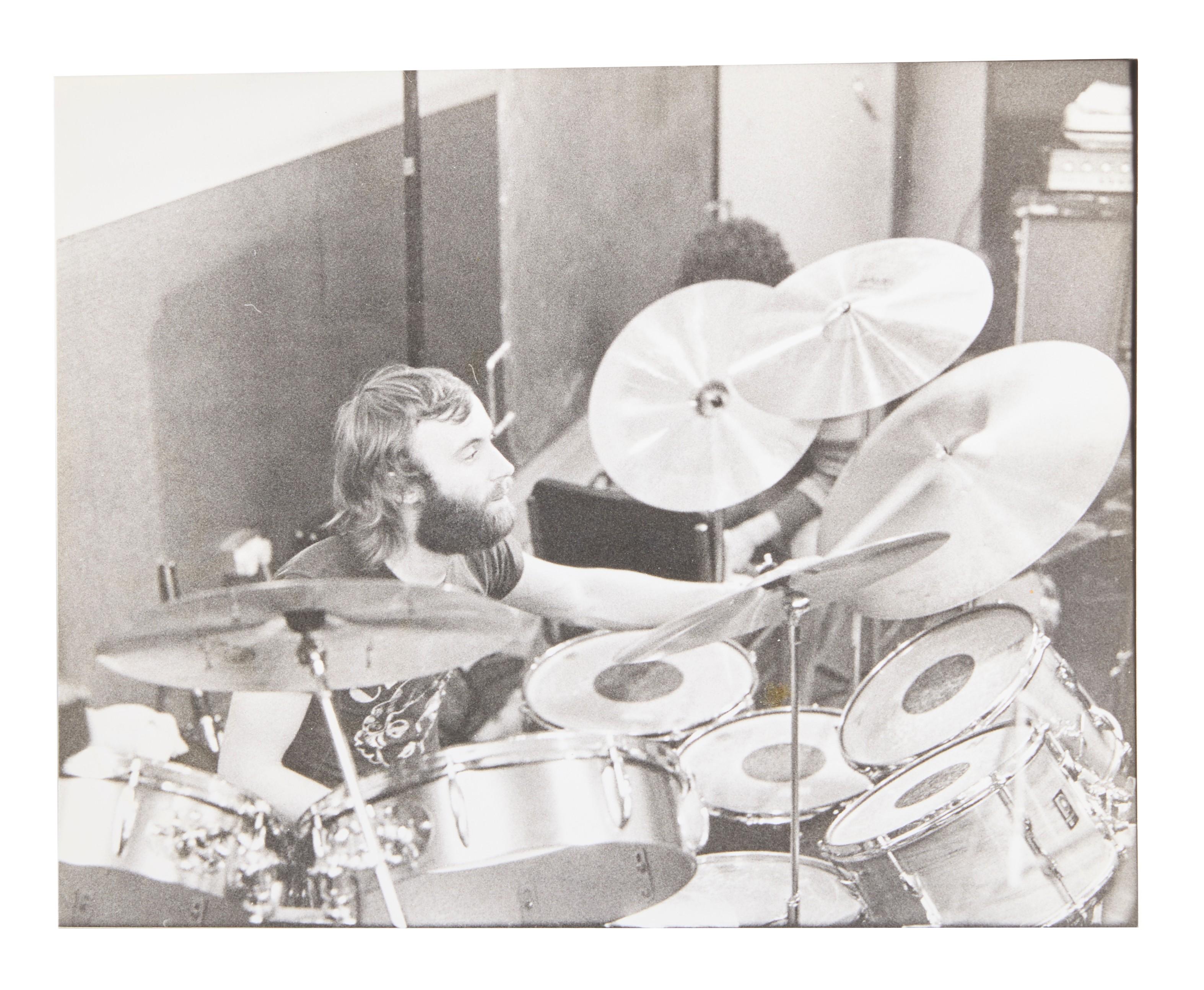 black and white image of phil collins playing the drums