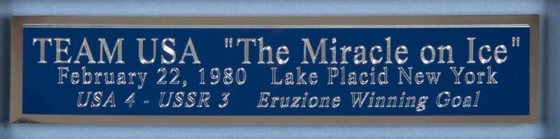 A blue plaque commemorating "The Miracle on Ice" hockey game, with silver text reading "TEAM USA 'The Miracle on Ice' February 22, 1980 Lake Placid New York USA 4 - USSR 3 Eruzione Winning Goal."