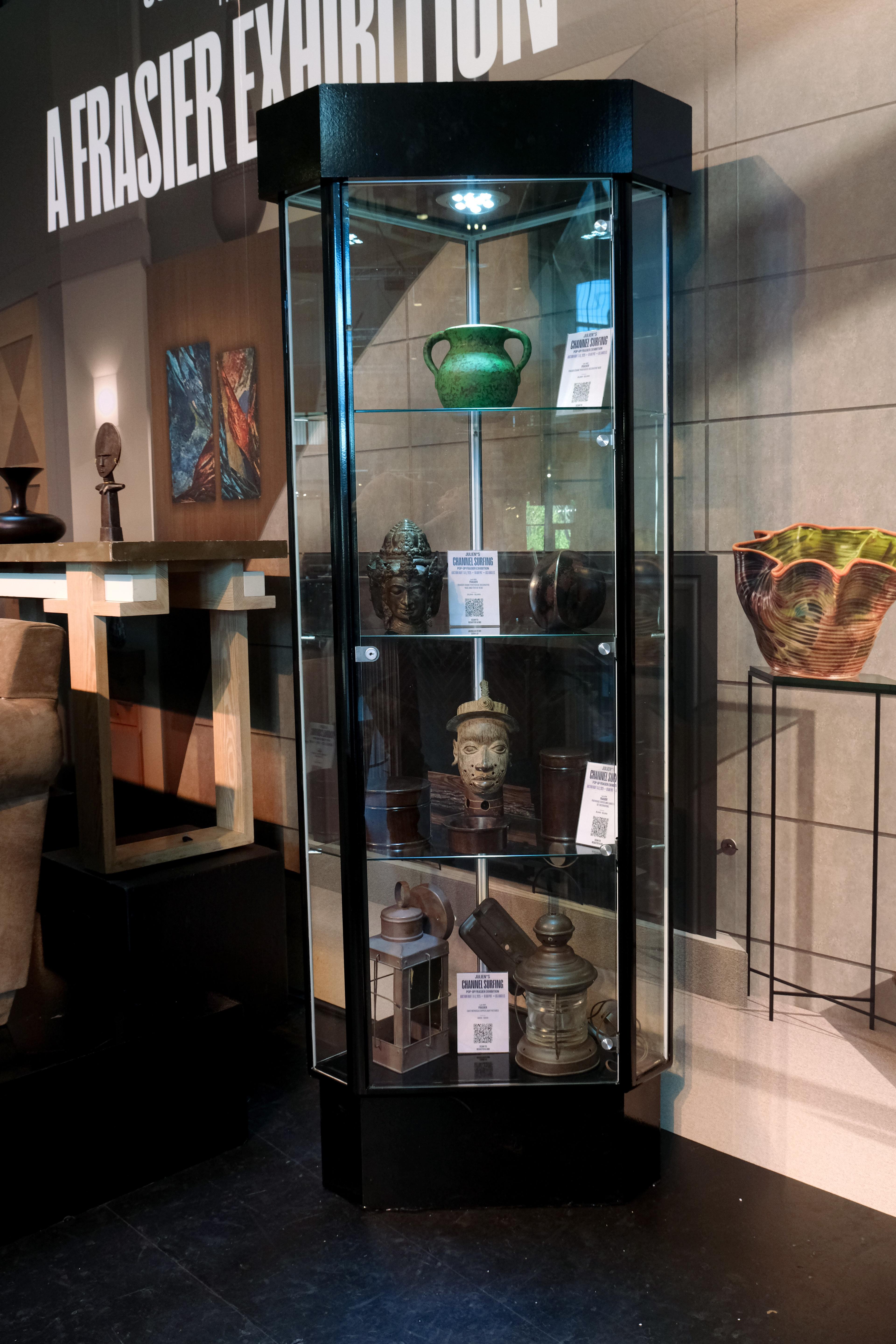 a glass display case with ceramic artifacts inside it