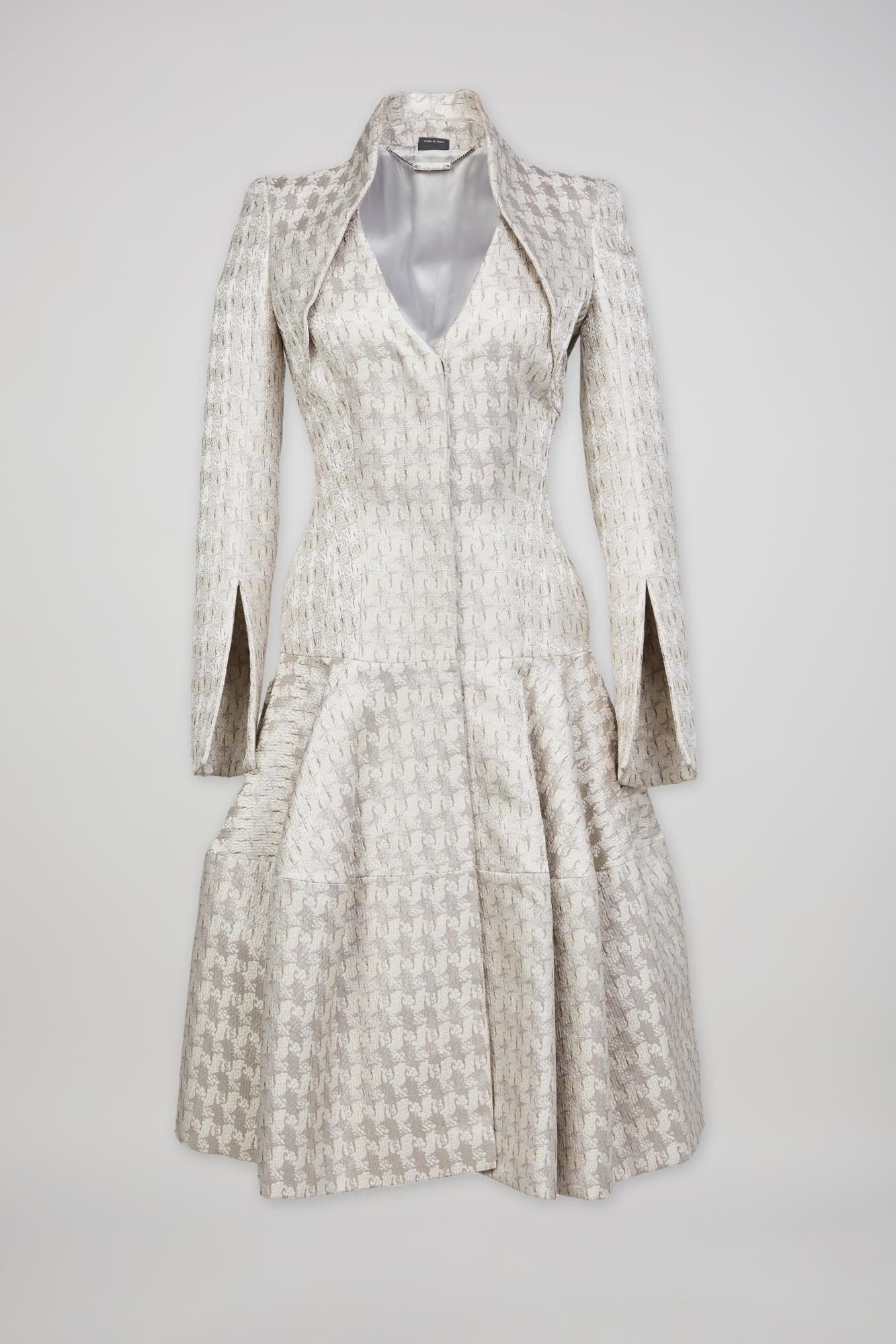 a white dress with a silver collar and sleeves