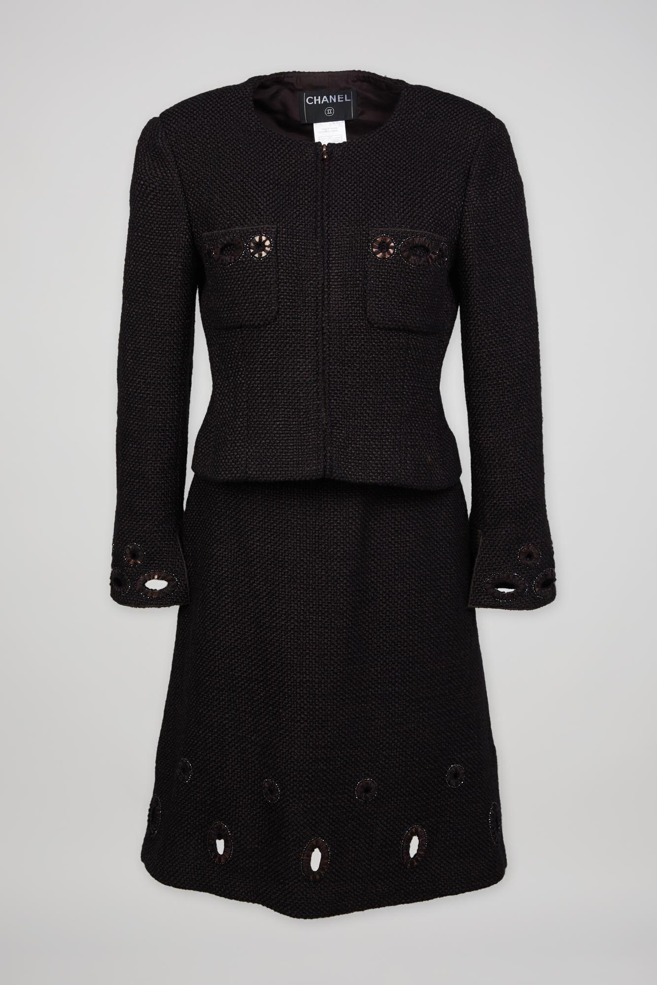 a black chanel suit is on a white background