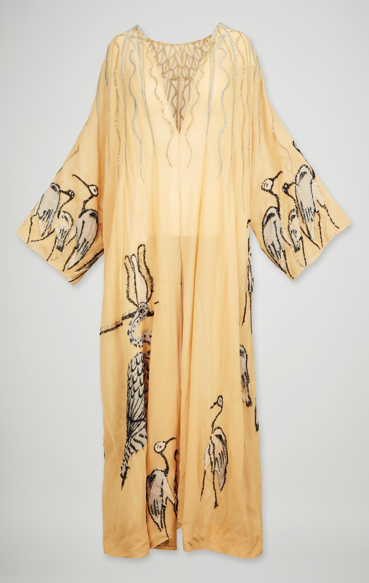 Lot #37. Elizabeth Taylor | Screen Worn "Cleopatra" Irene Sharraf Egyptian Revival Embroidered Evening Robe (With DVD) a yellow dress with birds embroidered on it