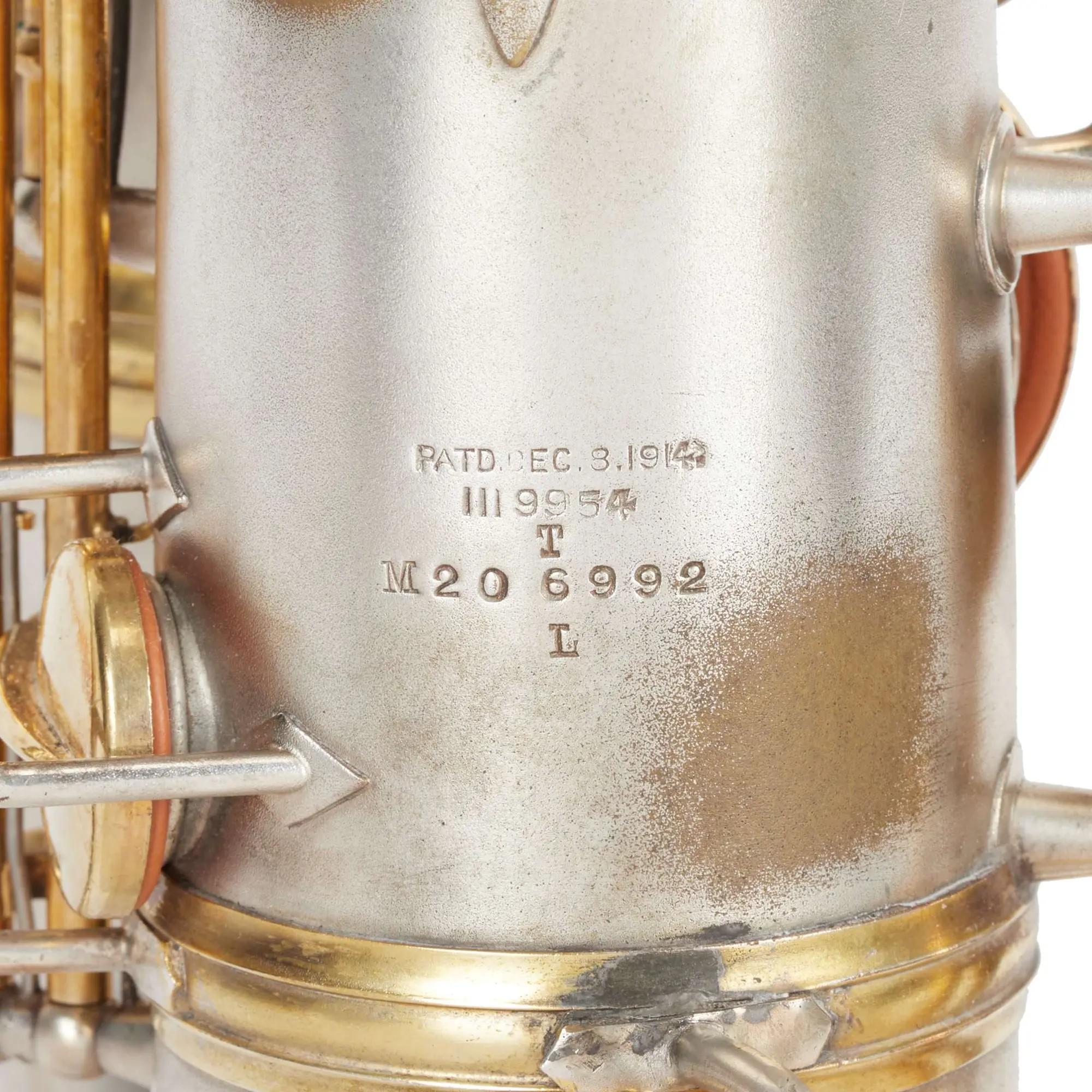 Silver saxophone body with engraved text including "PATD. DEC. 3. 1914," "III 9954," and "M20 6992."