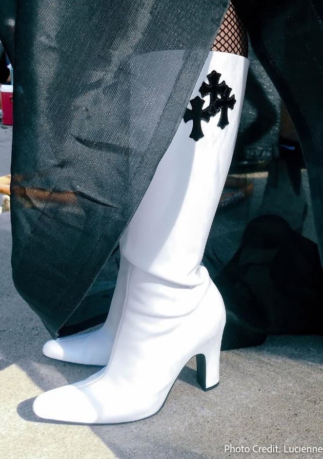 a pair of white boots with a black cross on the side